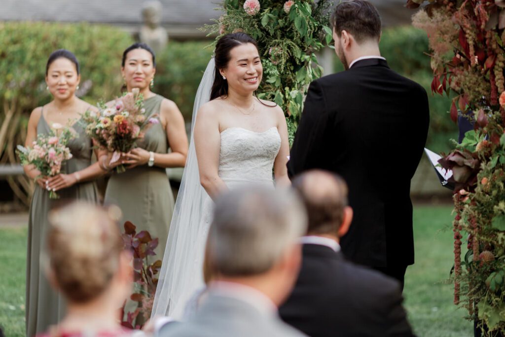 Vivian and Josh’s Gorgeous September Wedding at Arrow Park, NY
There’s something truly special about Arrow Park—it feels like my home away from home, and Vivian and Josh’s beautiful September wedding perfectly showcased everything this venue has to offer. Their blended celebration, honoring Vivian’s Korean heritage and Josh’s Jewish background, was a heartfelt and unforgettable day.
The couple beautifully wove their cultures into the festivities, from breaking the glass at the end of their garden ceremony to the lively horah during the reception. Later, Vivian and Josh delighted their guests by changing into traditional Korean hanbok outfits, a touching nod to her heritage.
Arrow Park: A Dream Venue for Multi-Day WeddingsVivian, Josh, and their loved ones all got ready at Arrow Park, which offers plenty of spacious accommodations for family and friends. This made it the perfect choice for their multi-day celebration. With its stunning grounds and versatile spaces, Arrow Park is ideal for couples seeking a wedding weekend filled with both elegance and comfort.
A Scenic September CelebrationThanks to the pleasant September weather, Vivian and Josh made full use of Arrow Park’s breathtaking grounds. Their day began with a magical first look along the iconic driveway lined with towering trees. From there, we explored the garden with its charming sculptures, captured moments by the ceremony’s floral décor, and took stunning portraits on the mansion’s iconic back staircase bathed in perfect lighting. We also ventured indoors for photos in the library and the Green Room, taking advantage of the mansion’s timeless charm.
As family and friends gathered, we captured formal portraits in front of the grand mansion before the ceremony began.
A Ceremony and Reception to RememberThe ceremony was set in the picturesque garden, where Jenny from Field Trip Flowers created a breathtaking floral backdrop that perfectly complemented the natural beauty of Arrow Park.
Afterward, guests strolled back to the mansion for a warm and inviting cocktail hour on the main floor. Later, everyone gathered in the courtyard for an enchanting outdoor reception under twinkling café lights. The space felt intimate yet grand, with the perfect blend of rustic elegance and romance.
Arrow Park’s charm, coupled with Vivian and Josh’s thoughtful cultural details, made this wedding one to remember. It’s the kind of venue where dreams come true—a hidden gem that’s ready to host your perfect day.
  
Thankful for all the wedding vendors that made this day possible:⁠
Venue: @arrowparkny
Floral: @fieldtripflowers
Catering: @lovenrosemary

Vivian and Josh Arrow Park NY Wedding documented by Karis from Hey Karis New York, Brooklyn, Hudson Valley NY and Catskills NY and NJ Wedding and NYC Elopement Photographer.