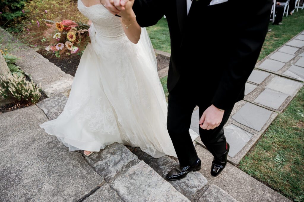 Vivian and Josh’s Gorgeous September Wedding at Arrow Park, NY
There’s something truly special about Arrow Park—it feels like my home away from home, and Vivian and Josh’s beautiful September wedding perfectly showcased everything this venue has to offer. Their blended celebration, honoring Vivian’s Korean heritage and Josh’s Jewish background, was a heartfelt and unforgettable day.
The couple beautifully wove their cultures into the festivities, from breaking the glass at the end of their garden ceremony to the lively horah during the reception. Later, Vivian and Josh delighted their guests by changing into traditional Korean hanbok outfits, a touching nod to her heritage.
Arrow Park: A Dream Venue for Multi-Day WeddingsVivian, Josh, and their loved ones all got ready at Arrow Park, which offers plenty of spacious accommodations for family and friends. This made it the perfect choice for their multi-day celebration. With its stunning grounds and versatile spaces, Arrow Park is ideal for couples seeking a wedding weekend filled with both elegance and comfort.
A Scenic September CelebrationThanks to the pleasant September weather, Vivian and Josh made full use of Arrow Park’s breathtaking grounds. Their day began with a magical first look along the iconic driveway lined with towering trees. From there, we explored the garden with its charming sculptures, captured moments by the ceremony’s floral décor, and took stunning portraits on the mansion’s iconic back staircase bathed in perfect lighting. We also ventured indoors for photos in the library and the Green Room, taking advantage of the mansion’s timeless charm.
As family and friends gathered, we captured formal portraits in front of the grand mansion before the ceremony began.
A Ceremony and Reception to RememberThe ceremony was set in the picturesque garden, where Jenny from Field Trip Flowers created a breathtaking floral backdrop that perfectly complemented the natural beauty of Arrow Park.
Afterward, guests strolled back to the mansion for a warm and inviting cocktail hour on the main floor. Later, everyone gathered in the courtyard for an enchanting outdoor reception under twinkling café lights. The space felt intimate yet grand, with the perfect blend of rustic elegance and romance.
Arrow Park’s charm, coupled with Vivian and Josh’s thoughtful cultural details, made this wedding one to remember. It’s the kind of venue where dreams come true—a hidden gem that’s ready to host your perfect day.
  
Thankful for all the wedding vendors that made this day possible:⁠
Venue: @arrowparkny
Floral: @fieldtripflowers

Vivian and Josh Arrow Park NY Wedding documented by Karis from Hey Karis New York, Brooklyn, Hudson Valley NY and Catskills NY and NJ Wedding and NYC Elopement Photographer.