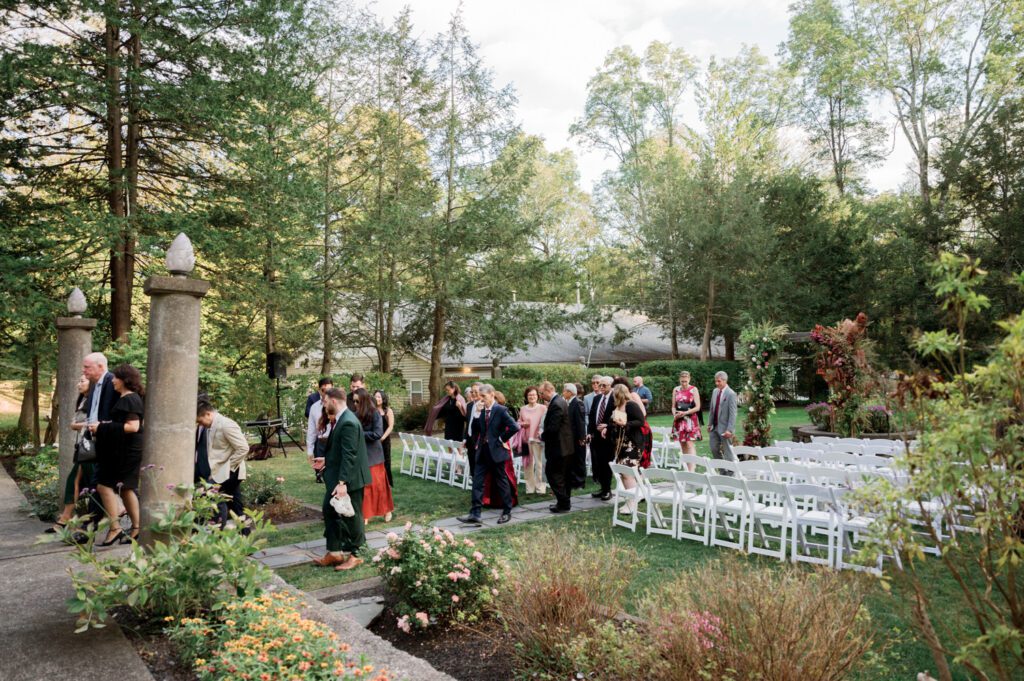 Vivian and Josh’s Gorgeous September Wedding at Arrow Park, NY
There’s something truly special about Arrow Park—it feels like my home away from home, and Vivian and Josh’s beautiful September wedding perfectly showcased everything this venue has to offer. Their blended celebration, honoring Vivian’s Korean heritage and Josh’s Jewish background, was a heartfelt and unforgettable day.
The couple beautifully wove their cultures into the festivities, from breaking the glass at the end of their garden ceremony to the lively horah during the reception. Later, Vivian and Josh delighted their guests by changing into traditional Korean hanbok outfits, a touching nod to her heritage.
Arrow Park: A Dream Venue for Multi-Day WeddingsVivian, Josh, and their loved ones all got ready at Arrow Park, which offers plenty of spacious accommodations for family and friends. This made it the perfect choice for their multi-day celebration. With its stunning grounds and versatile spaces, Arrow Park is ideal for couples seeking a wedding weekend filled with both elegance and comfort.
A Scenic September CelebrationThanks to the pleasant September weather, Vivian and Josh made full use of Arrow Park’s breathtaking grounds. Their day began with a magical first look along the iconic driveway lined with towering trees. From there, we explored the garden with its charming sculptures, captured moments by the ceremony’s floral décor, and took stunning portraits on the mansion’s iconic back staircase bathed in perfect lighting. We also ventured indoors for photos in the library and the Green Room, taking advantage of the mansion’s timeless charm.
As family and friends gathered, we captured formal portraits in front of the grand mansion before the ceremony began.
A Ceremony and Reception to RememberThe ceremony was set in the picturesque garden, where Jenny from Field Trip Flowers created a breathtaking floral backdrop that perfectly complemented the natural beauty of Arrow Park.
Afterward, guests strolled back to the mansion for a warm and inviting cocktail hour on the main floor. Later, everyone gathered in the courtyard for an enchanting outdoor reception under twinkling café lights. The space felt intimate yet grand, with the perfect blend of rustic elegance and romance.
Arrow Park’s charm, coupled with Vivian and Josh’s thoughtful cultural details, made this wedding one to remember. It’s the kind of venue where dreams come true—a hidden gem that’s ready to host your perfect day.
  
Thankful for all the wedding vendors that made this day possible:⁠
Venue: @arrowparkny
Floral: @fieldtripflowers

Vivian and Josh Arrow Park NY Wedding documented by Karis from Hey Karis New York, Brooklyn, Hudson Valley NY and Catskills NY and NJ Wedding and NYC Elopement Photographer.