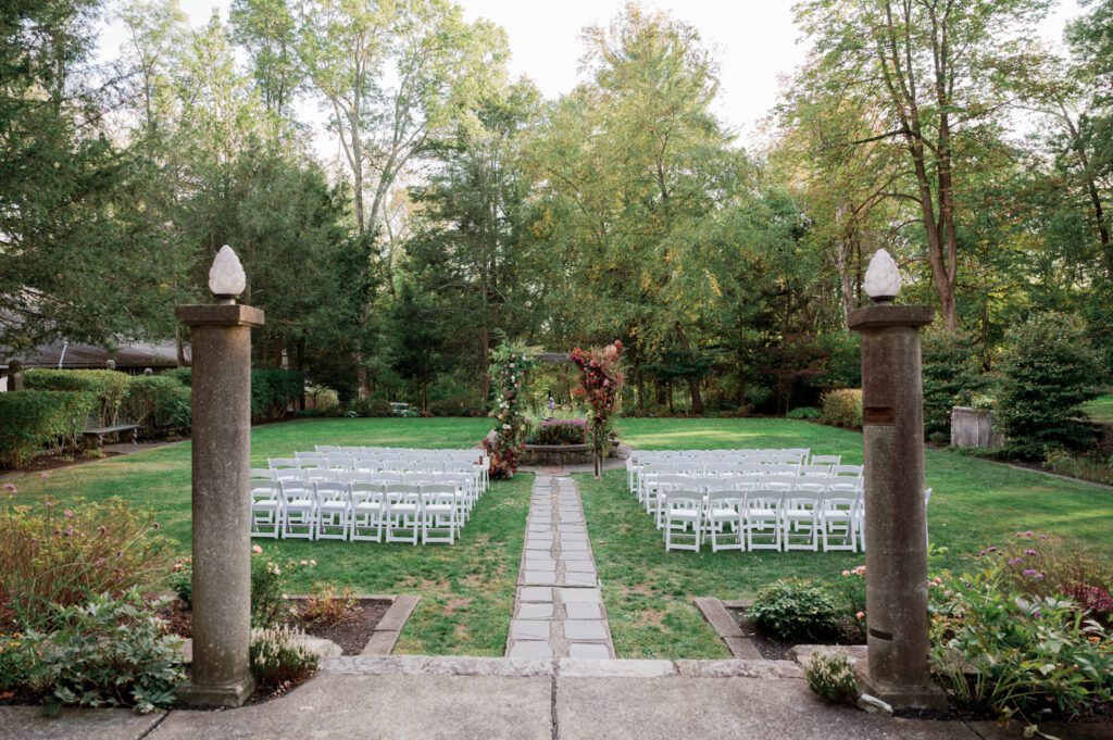 Vivian and Josh’s Gorgeous September Wedding at Arrow Park, NY
There’s something truly special about Arrow Park—it feels like my home away from home, and Vivian and Josh’s beautiful September wedding perfectly showcased everything this venue has to offer. Their blended celebration, honoring Vivian’s Korean heritage and Josh’s Jewish background, was a heartfelt and unforgettable day.
The couple beautifully wove their cultures into the festivities, from breaking the glass at the end of their garden ceremony to the lively horah during the reception. Later, Vivian and Josh delighted their guests by changing into traditional Korean hanbok outfits, a touching nod to her heritage.
Arrow Park: A Dream Venue for Multi-Day WeddingsVivian, Josh, and their loved ones all got ready at Arrow Park, which offers plenty of spacious accommodations for family and friends. This made it the perfect choice for their multi-day celebration. With its stunning grounds and versatile spaces, Arrow Park is ideal for couples seeking a wedding weekend filled with both elegance and comfort.
A Scenic September CelebrationThanks to the pleasant September weather, Vivian and Josh made full use of Arrow Park’s breathtaking grounds. Their day began with a magical first look along the iconic driveway lined with towering trees. From there, we explored the garden with its charming sculptures, captured moments by the ceremony’s floral décor, and took stunning portraits on the mansion’s iconic back staircase bathed in perfect lighting. We also ventured indoors for photos in the library and the Green Room, taking advantage of the mansion’s timeless charm.
As family and friends gathered, we captured formal portraits in front of the grand mansion before the ceremony began.
A Ceremony and Reception to RememberThe ceremony was set in the picturesque garden, where Jenny from Field Trip Flowers created a breathtaking floral backdrop that perfectly complemented the natural beauty of Arrow Park.
Afterward, guests strolled back to the mansion for a warm and inviting cocktail hour on the main floor. Later, everyone gathered in the courtyard for an enchanting outdoor reception under twinkling café lights. The space felt intimate yet grand, with the perfect blend of rustic elegance and romance.
Arrow Park’s charm, coupled with Vivian and Josh’s thoughtful cultural details, made this wedding one to remember. It’s the kind of venue where dreams come true—a hidden gem that’s ready to host your perfect day.
  
Thankful for all the wedding vendors that made this day possible:⁠
Venue: @arrowparkny
Floral: @fieldtripflowers
Catering: @lovenrosemary

Vivian and Josh Arrow Park NY Wedding documented by Karis from Hey Karis New York, Brooklyn, Hudson Valley NY and Catskills NY and NJ Wedding and NYC Elopement Photographer.
