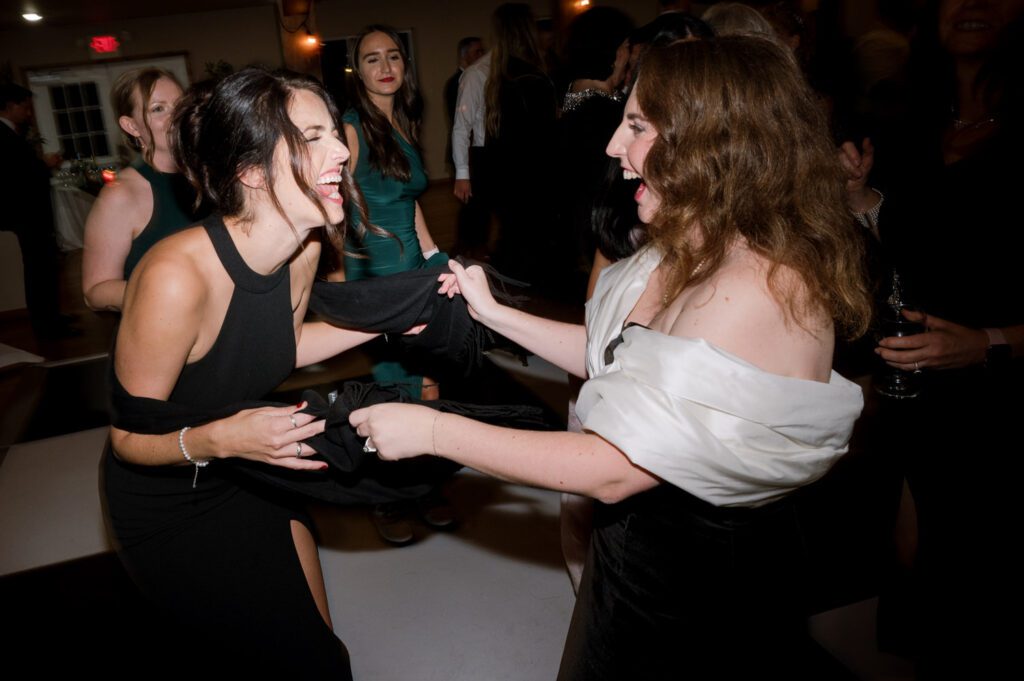 Kirsten and AJ’s September Wedding at Arrow Park, NY
Kirsten and AJ’s wedding day was a bit chilly and rainy, but their flexibility and positivity turned the day into a magical celebration. Originally planned for the garden, the ceremony was moved indoors due to the autumn rain. The staff at Arrow Park seamlessly transitioned the setup to the mansion’s main floor, creating an intimate and elegant ceremony space. The historic charm of the mansion, with its grand details and warm ambiance, added a cozy, romantic touch to their special day.
Kirsten, a talented fashion designer, surprised everyone—including her groom, AJ—by wearing a stunning black velvet strapless dress with an oversized white bow draping dramatically down the back. She designed the dress herself, and it was a show-stopper that perfectly reflected her unique style. The ceremony was heartfelt and personal, with family and friends gathering close to witness Kirsten and AJ’s vows.
After the ceremony, the main mansion was transformed to host a lively cocktail hour. Guests mingled and enjoyed delicious hors d'oeuvres while the reception space in the pavilion was being prepared. Kirsten and AJ’s attention to detail shone through in their décor choices, including the black-and-white checkered flooring that gave the pavilion a retro vibe. It was a perfect blend of modern chic and classic sophistication.
The reception began with Kirsten and AJ’s grand entrance, greeted by cheers from their guests. Their first dance was sweet and endearing, setting the tone for a night of joy and celebration. As the evening progressed, the party ramped up with enthusiastic dancing, heartfelt toasts, and even a surprise performance—a few uncles took the mic for an impromptu rap song that brought the house down.
Arrow Park provided the perfect backdrop for Kirsten and AJ’s wedding. With its blend of natural beauty and historic architecture, it’s an ideal venue for couples seeking a mix of indoor and outdoor spaces. The mansion offers a timeless elegance, while the pavilion provides a versatile setting for larger receptions.
Planning Tips for Future Couples at Arrow Park:
1. Have a Rain Plan: September weather can be unpredictable, so work with the Arrow Park staff to plan for both indoor and outdoor options. The mansion’s interiors provide a stunning alternative for ceremonies or cocktail hours.
2. Maximize the Pavilion: The pavilion’s spacious layout can accommodate various themes and setups. Consider unique flooring, lighting, or drapery to make the space your own.
3. Embrace the Venue’s Charm: Use the mansion’s historic features—like the fireplaces and vintage decor—as part of your wedding aesthetic. It’s a built-in backdrop that needs little embellishment.
4. Plan Time for Photos: Arrow Park’s grounds are breathtaking, especially in the fall. Schedule time with your photographer to capture the beauty of the lake, gardens, and mansion.
Kirsten and AJ’s wedding was a true testament to the power of creativity, adaptability, and love. Their celebration at Arrow Park was unforgettable, and I’m grateful to have been a part of their special day.
Thankful for all the wedding vendors that made this day possible:⁠
Venue: @arrowparkny
Catering: @lovenrosemary
Kirsten and AJ Arrow Park NY Wedding documented by Karis from Hey Karis New York, Brooklyn, Hudson Valley NY and Catskills NY and NJ Wedding and NYC Elopement Photographer.