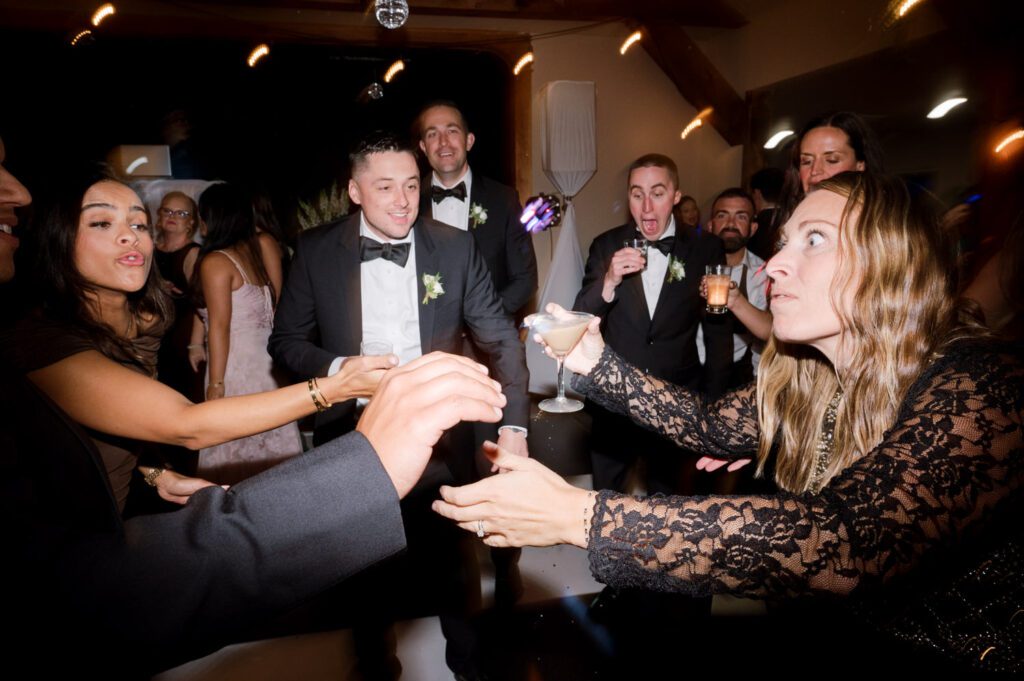 Kirsten and AJ’s September Wedding at Arrow Park, NY
Kirsten and AJ’s wedding day was a bit chilly and rainy, but their flexibility and positivity turned the day into a magical celebration. Originally planned for the garden, the ceremony was moved indoors due to the autumn rain. The staff at Arrow Park seamlessly transitioned the setup to the mansion’s main floor, creating an intimate and elegant ceremony space. The historic charm of the mansion, with its grand details and warm ambiance, added a cozy, romantic touch to their special day.
Kirsten, a talented fashion designer, surprised everyone—including her groom, AJ—by wearing a stunning black velvet strapless dress with an oversized white bow draping dramatically down the back. She designed the dress herself, and it was a show-stopper that perfectly reflected her unique style. The ceremony was heartfelt and personal, with family and friends gathering close to witness Kirsten and AJ’s vows.
After the ceremony, the main mansion was transformed to host a lively cocktail hour. Guests mingled and enjoyed delicious hors d'oeuvres while the reception space in the pavilion was being prepared. Kirsten and AJ’s attention to detail shone through in their décor choices, including the black-and-white checkered flooring that gave the pavilion a retro vibe. It was a perfect blend of modern chic and classic sophistication.
The reception began with Kirsten and AJ’s grand entrance, greeted by cheers from their guests. Their first dance was sweet and endearing, setting the tone for a night of joy and celebration. As the evening progressed, the party ramped up with enthusiastic dancing, heartfelt toasts, and even a surprise performance—a few uncles took the mic for an impromptu rap song that brought the house down.
Arrow Park provided the perfect backdrop for Kirsten and AJ’s wedding. With its blend of natural beauty and historic architecture, it’s an ideal venue for couples seeking a mix of indoor and outdoor spaces. The mansion offers a timeless elegance, while the pavilion provides a versatile setting for larger receptions.
Planning Tips for Future Couples at Arrow Park:
1. Have a Rain Plan: September weather can be unpredictable, so work with the Arrow Park staff to plan for both indoor and outdoor options. The mansion’s interiors provide a stunning alternative for ceremonies or cocktail hours.
2. Maximize the Pavilion: The pavilion’s spacious layout can accommodate various themes and setups. Consider unique flooring, lighting, or drapery to make the space your own.
3. Embrace the Venue’s Charm: Use the mansion’s historic features—like the fireplaces and vintage decor—as part of your wedding aesthetic. It’s a built-in backdrop that needs little embellishment.
4. Plan Time for Photos: Arrow Park’s grounds are breathtaking, especially in the fall. Schedule time with your photographer to capture the beauty of the lake, gardens, and mansion.
Kirsten and AJ’s wedding was a true testament to the power of creativity, adaptability, and love. Their celebration at Arrow Park was unforgettable, and I’m grateful to have been a part of their special day.
Thankful for all the wedding vendors that made this day possible:⁠
Venue: @arrowparkny
Catering: @lovenrosemary
Kirsten and AJ Arrow Park NY Wedding documented by Karis from Hey Karis New York, Brooklyn, Hudson Valley NY and Catskills NY and NJ Wedding and NYC Elopement Photographer.