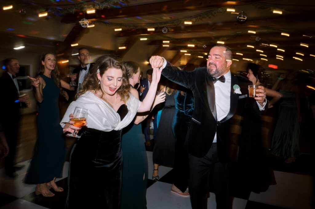 Kirsten and AJ’s September Wedding at Arrow Park, NY
Kirsten and AJ’s wedding day was a bit chilly and rainy, but their flexibility and positivity turned the day into a magical celebration. Originally planned for the garden, the ceremony was moved indoors due to the autumn rain. The staff at Arrow Park seamlessly transitioned the setup to the mansion’s main floor, creating an intimate and elegant ceremony space. The historic charm of the mansion, with its grand details and warm ambiance, added a cozy, romantic touch to their special day.
Kirsten, a talented fashion designer, surprised everyone—including her groom, AJ—by wearing a stunning black velvet strapless dress with an oversized white bow draping dramatically down the back. She designed the dress herself, and it was a show-stopper that perfectly reflected her unique style. The ceremony was heartfelt and personal, with family and friends gathering close to witness Kirsten and AJ’s vows.
After the ceremony, the main mansion was transformed to host a lively cocktail hour. Guests mingled and enjoyed delicious hors d'oeuvres while the reception space in the pavilion was being prepared. Kirsten and AJ’s attention to detail shone through in their décor choices, including the black-and-white checkered flooring that gave the pavilion a retro vibe. It was a perfect blend of modern chic and classic sophistication.
The reception began with Kirsten and AJ’s grand entrance, greeted by cheers from their guests. Their first dance was sweet and endearing, setting the tone for a night of joy and celebration. As the evening progressed, the party ramped up with enthusiastic dancing, heartfelt toasts, and even a surprise performance—a few uncles took the mic for an impromptu rap song that brought the house down.
Arrow Park provided the perfect backdrop for Kirsten and AJ’s wedding. With its blend of natural beauty and historic architecture, it’s an ideal venue for couples seeking a mix of indoor and outdoor spaces. The mansion offers a timeless elegance, while the pavilion provides a versatile setting for larger receptions.
Planning Tips for Future Couples at Arrow Park:
1. Have a Rain Plan: September weather can be unpredictable, so work with the Arrow Park staff to plan for both indoor and outdoor options. The mansion’s interiors provide a stunning alternative for ceremonies or cocktail hours.
2. Maximize the Pavilion: The pavilion’s spacious layout can accommodate various themes and setups. Consider unique flooring, lighting, or drapery to make the space your own.
3. Embrace the Venue’s Charm: Use the mansion’s historic features—like the fireplaces and vintage decor—as part of your wedding aesthetic. It’s a built-in backdrop that needs little embellishment.
4. Plan Time for Photos: Arrow Park’s grounds are breathtaking, especially in the fall. Schedule time with your photographer to capture the beauty of the lake, gardens, and mansion.
Kirsten and AJ’s wedding was a true testament to the power of creativity, adaptability, and love. Their celebration at Arrow Park was unforgettable, and I’m grateful to have been a part of their special day.
Thankful for all the wedding vendors that made this day possible:⁠
Venue: @arrowparkny
Catering: @lovenrosemary
Kirsten and AJ Arrow Park NY Wedding documented by Karis from Hey Karis New York, Brooklyn, Hudson Valley NY and Catskills NY and NJ Wedding and NYC Elopement Photographer.