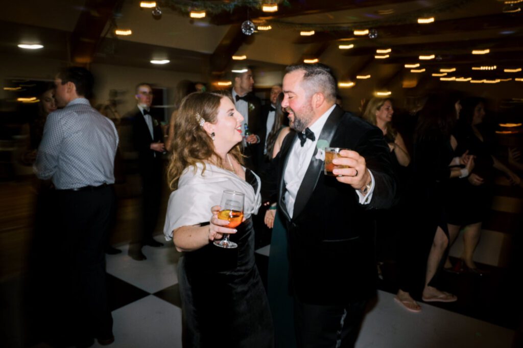 Kirsten and AJ’s September Wedding at Arrow Park, NY
Kirsten and AJ’s wedding day was a bit chilly and rainy, but their flexibility and positivity turned the day into a magical celebration. Originally planned for the garden, the ceremony was moved indoors due to the autumn rain. The staff at Arrow Park seamlessly transitioned the setup to the mansion’s main floor, creating an intimate and elegant ceremony space. The historic charm of the mansion, with its grand details and warm ambiance, added a cozy, romantic touch to their special day.
Kirsten, a talented fashion designer, surprised everyone—including her groom, AJ—by wearing a stunning black velvet strapless dress with an oversized white bow draping dramatically down the back. She designed the dress herself, and it was a show-stopper that perfectly reflected her unique style. The ceremony was heartfelt and personal, with family and friends gathering close to witness Kirsten and AJ’s vows.
After the ceremony, the main mansion was transformed to host a lively cocktail hour. Guests mingled and enjoyed delicious hors d'oeuvres while the reception space in the pavilion was being prepared. Kirsten and AJ’s attention to detail shone through in their décor choices, including the black-and-white checkered flooring that gave the pavilion a retro vibe. It was a perfect blend of modern chic and classic sophistication.
The reception began with Kirsten and AJ’s grand entrance, greeted by cheers from their guests. Their first dance was sweet and endearing, setting the tone for a night of joy and celebration. As the evening progressed, the party ramped up with enthusiastic dancing, heartfelt toasts, and even a surprise performance—a few uncles took the mic for an impromptu rap song that brought the house down.
Arrow Park provided the perfect backdrop for Kirsten and AJ’s wedding. With its blend of natural beauty and historic architecture, it’s an ideal venue for couples seeking a mix of indoor and outdoor spaces. The mansion offers a timeless elegance, while the pavilion provides a versatile setting for larger receptions.
Planning Tips for Future Couples at Arrow Park:
1. Have a Rain Plan: September weather can be unpredictable, so work with the Arrow Park staff to plan for both indoor and outdoor options. The mansion’s interiors provide a stunning alternative for ceremonies or cocktail hours.
2. Maximize the Pavilion: The pavilion’s spacious layout can accommodate various themes and setups. Consider unique flooring, lighting, or drapery to make the space your own.
3. Embrace the Venue’s Charm: Use the mansion’s historic features—like the fireplaces and vintage decor—as part of your wedding aesthetic. It’s a built-in backdrop that needs little embellishment.
4. Plan Time for Photos: Arrow Park’s grounds are breathtaking, especially in the fall. Schedule time with your photographer to capture the beauty of the lake, gardens, and mansion.
Kirsten and AJ’s wedding was a true testament to the power of creativity, adaptability, and love. Their celebration at Arrow Park was unforgettable, and I’m grateful to have been a part of their special day.
Thankful for all the wedding vendors that made this day possible:⁠
Venue: @arrowparkny
Catering: @lovenrosemary
Kirsten and AJ Arrow Park NY Wedding documented by Karis from Hey Karis New York, Brooklyn, Hudson Valley NY and Catskills NY and NJ Wedding and NYC Elopement Photographer.