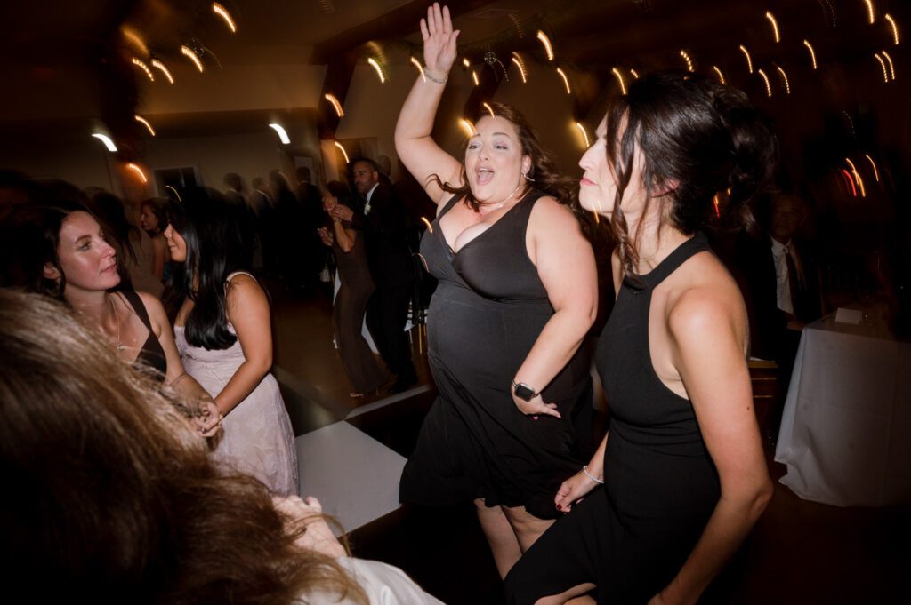 Kirsten and AJ’s September Wedding at Arrow Park, NY
Kirsten and AJ’s wedding day was a bit chilly and rainy, but their flexibility and positivity turned the day into a magical celebration. Originally planned for the garden, the ceremony was moved indoors due to the autumn rain. The staff at Arrow Park seamlessly transitioned the setup to the mansion’s main floor, creating an intimate and elegant ceremony space. The historic charm of the mansion, with its grand details and warm ambiance, added a cozy, romantic touch to their special day.
Kirsten, a talented fashion designer, surprised everyone—including her groom, AJ—by wearing a stunning black velvet strapless dress with an oversized white bow draping dramatically down the back. She designed the dress herself, and it was a show-stopper that perfectly reflected her unique style. The ceremony was heartfelt and personal, with family and friends gathering close to witness Kirsten and AJ’s vows.
After the ceremony, the main mansion was transformed to host a lively cocktail hour. Guests mingled and enjoyed delicious hors d'oeuvres while the reception space in the pavilion was being prepared. Kirsten and AJ’s attention to detail shone through in their décor choices, including the black-and-white checkered flooring that gave the pavilion a retro vibe. It was a perfect blend of modern chic and classic sophistication.
The reception began with Kirsten and AJ’s grand entrance, greeted by cheers from their guests. Their first dance was sweet and endearing, setting the tone for a night of joy and celebration. As the evening progressed, the party ramped up with enthusiastic dancing, heartfelt toasts, and even a surprise performance—a few uncles took the mic for an impromptu rap song that brought the house down.
Arrow Park provided the perfect backdrop for Kirsten and AJ’s wedding. With its blend of natural beauty and historic architecture, it’s an ideal venue for couples seeking a mix of indoor and outdoor spaces. The mansion offers a timeless elegance, while the pavilion provides a versatile setting for larger receptions.
Planning Tips for Future Couples at Arrow Park:
1. Have a Rain Plan: September weather can be unpredictable, so work with the Arrow Park staff to plan for both indoor and outdoor options. The mansion’s interiors provide a stunning alternative for ceremonies or cocktail hours.
2. Maximize the Pavilion: The pavilion’s spacious layout can accommodate various themes and setups. Consider unique flooring, lighting, or drapery to make the space your own.
3. Embrace the Venue’s Charm: Use the mansion’s historic features—like the fireplaces and vintage decor—as part of your wedding aesthetic. It’s a built-in backdrop that needs little embellishment.
4. Plan Time for Photos: Arrow Park’s grounds are breathtaking, especially in the fall. Schedule time with your photographer to capture the beauty of the lake, gardens, and mansion.
Kirsten and AJ’s wedding was a true testament to the power of creativity, adaptability, and love. Their celebration at Arrow Park was unforgettable, and I’m grateful to have been a part of their special day.
Thankful for all the wedding vendors that made this day possible:⁠
Venue: @arrowparkny
Catering: @lovenrosemary
Kirsten and AJ Arrow Park NY Wedding documented by Karis from Hey Karis New York, Brooklyn, Hudson Valley NY and Catskills NY and NJ Wedding and NYC Elopement Photographer.