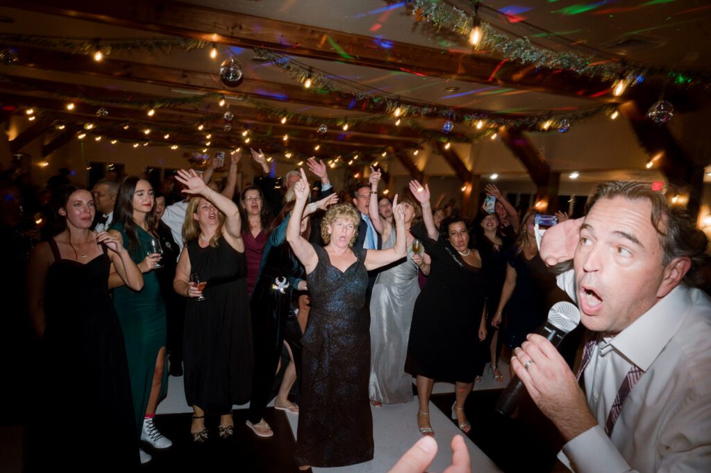 Kirsten and AJ’s September Wedding at Arrow Park, NY
Kirsten and AJ’s wedding day was a bit chilly and rainy, but their flexibility and positivity turned the day into a magical celebration. Originally planned for the garden, the ceremony was moved indoors due to the autumn rain. The staff at Arrow Park seamlessly transitioned the setup to the mansion’s main floor, creating an intimate and elegant ceremony space. The historic charm of the mansion, with its grand details and warm ambiance, added a cozy, romantic touch to their special day.
Kirsten, a talented fashion designer, surprised everyone—including her groom, AJ—by wearing a stunning black velvet strapless dress with an oversized white bow draping dramatically down the back. She designed the dress herself, and it was a show-stopper that perfectly reflected her unique style. The ceremony was heartfelt and personal, with family and friends gathering close to witness Kirsten and AJ’s vows.
After the ceremony, the main mansion was transformed to host a lively cocktail hour. Guests mingled and enjoyed delicious hors d'oeuvres while the reception space in the pavilion was being prepared. Kirsten and AJ’s attention to detail shone through in their décor choices, including the black-and-white checkered flooring that gave the pavilion a retro vibe. It was a perfect blend of modern chic and classic sophistication.
The reception began with Kirsten and AJ’s grand entrance, greeted by cheers from their guests. Their first dance was sweet and endearing, setting the tone for a night of joy and celebration. As the evening progressed, the party ramped up with enthusiastic dancing, heartfelt toasts, and even a surprise performance—a few uncles took the mic for an impromptu rap song that brought the house down.
Arrow Park provided the perfect backdrop for Kirsten and AJ’s wedding. With its blend of natural beauty and historic architecture, it’s an ideal venue for couples seeking a mix of indoor and outdoor spaces. The mansion offers a timeless elegance, while the pavilion provides a versatile setting for larger receptions.
Planning Tips for Future Couples at Arrow Park:
1. Have a Rain Plan: September weather can be unpredictable, so work with the Arrow Park staff to plan for both indoor and outdoor options. The mansion’s interiors provide a stunning alternative for ceremonies or cocktail hours.
2. Maximize the Pavilion: The pavilion’s spacious layout can accommodate various themes and setups. Consider unique flooring, lighting, or drapery to make the space your own.
3. Embrace the Venue’s Charm: Use the mansion’s historic features—like the fireplaces and vintage decor—as part of your wedding aesthetic. It’s a built-in backdrop that needs little embellishment.
4. Plan Time for Photos: Arrow Park’s grounds are breathtaking, especially in the fall. Schedule time with your photographer to capture the beauty of the lake, gardens, and mansion.
Kirsten and AJ’s wedding was a true testament to the power of creativity, adaptability, and love. Their celebration at Arrow Park was unforgettable, and I’m grateful to have been a part of their special day.
Thankful for all the wedding vendors that made this day possible:⁠
Venue: @arrowparkny
Catering: @lovenrosemary
Kirsten and AJ Arrow Park NY Wedding documented by Karis from Hey Karis New York, Brooklyn, Hudson Valley NY and Catskills NY and NJ Wedding and NYC Elopement Photographer.