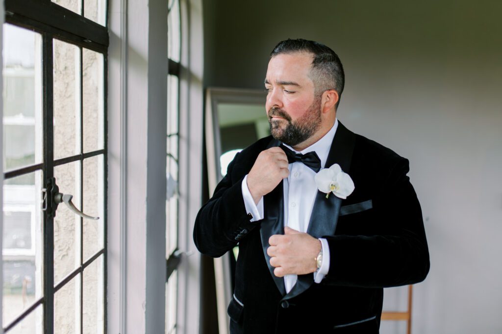 Kirsten and AJ’s September Wedding at Arrow Park, NY
Kirsten and AJ’s wedding day was a bit chilly and rainy, but their flexibility and positivity turned the day into a magical celebration. Originally planned for the garden, the ceremony was moved indoors due to the autumn rain. The staff at Arrow Park seamlessly transitioned the setup to the mansion’s main floor, creating an intimate and elegant ceremony space. The historic charm of the mansion, with its grand details and warm ambiance, added a cozy, romantic touch to their special day.
Kirsten, a talented fashion designer, surprised everyone—including her groom, AJ—by wearing a stunning black velvet strapless dress with an oversized white bow draping dramatically down the back. She designed the dress herself, and it was a show-stopper that perfectly reflected her unique style. The ceremony was heartfelt and personal, with family and friends gathering close to witness Kirsten and AJ’s vows.
After the ceremony, the main mansion was transformed to host a lively cocktail hour. Guests mingled and enjoyed delicious hors d'oeuvres while the reception space in the pavilion was being prepared. Kirsten and AJ’s attention to detail shone through in their décor choices, including the black-and-white checkered flooring that gave the pavilion a retro vibe. It was a perfect blend of modern chic and classic sophistication.
The reception began with Kirsten and AJ’s grand entrance, greeted by cheers from their guests. Their first dance was sweet and endearing, setting the tone for a night of joy and celebration. As the evening progressed, the party ramped up with enthusiastic dancing, heartfelt toasts, and even a surprise performance—a few uncles took the mic for an impromptu rap song that brought the house down.
Arrow Park provided the perfect backdrop for Kirsten and AJ’s wedding. With its blend of natural beauty and historic architecture, it’s an ideal venue for couples seeking a mix of indoor and outdoor spaces. The mansion offers a timeless elegance, while the pavilion provides a versatile setting for larger receptions.
Planning Tips for Future Couples at Arrow Park:
1. Have a Rain Plan: September weather can be unpredictable, so work with the Arrow Park staff to plan for both indoor and outdoor options. The mansion’s interiors provide a stunning alternative for ceremonies or cocktail hours.
2. Maximize the Pavilion: The pavilion’s spacious layout can accommodate various themes and setups. Consider unique flooring, lighting, or drapery to make the space your own.
3. Embrace the Venue’s Charm: Use the mansion’s historic features—like the fireplaces and vintage decor—as part of your wedding aesthetic. It’s a built-in backdrop that needs little embellishment.
4. Plan Time for Photos: Arrow Park’s grounds are breathtaking, especially in the fall. Schedule time with your photographer to capture the beauty of the lake, gardens, and mansion.
Kirsten and AJ’s wedding was a true testament to the power of creativity, adaptability, and love. Their celebration at Arrow Park was unforgettable, and I’m grateful to have been a part of their special day.
Thankful for all the wedding vendors that made this day possible:⁠
Venue: @arrowparkny
Catering: @lovenrosemary
Kirsten and AJ Arrow Park NY Wedding documented by Karis from Hey Karis New York, Brooklyn, Hudson Valley NY and Catskills NY and NJ Wedding and NYC Elopement Photographer.