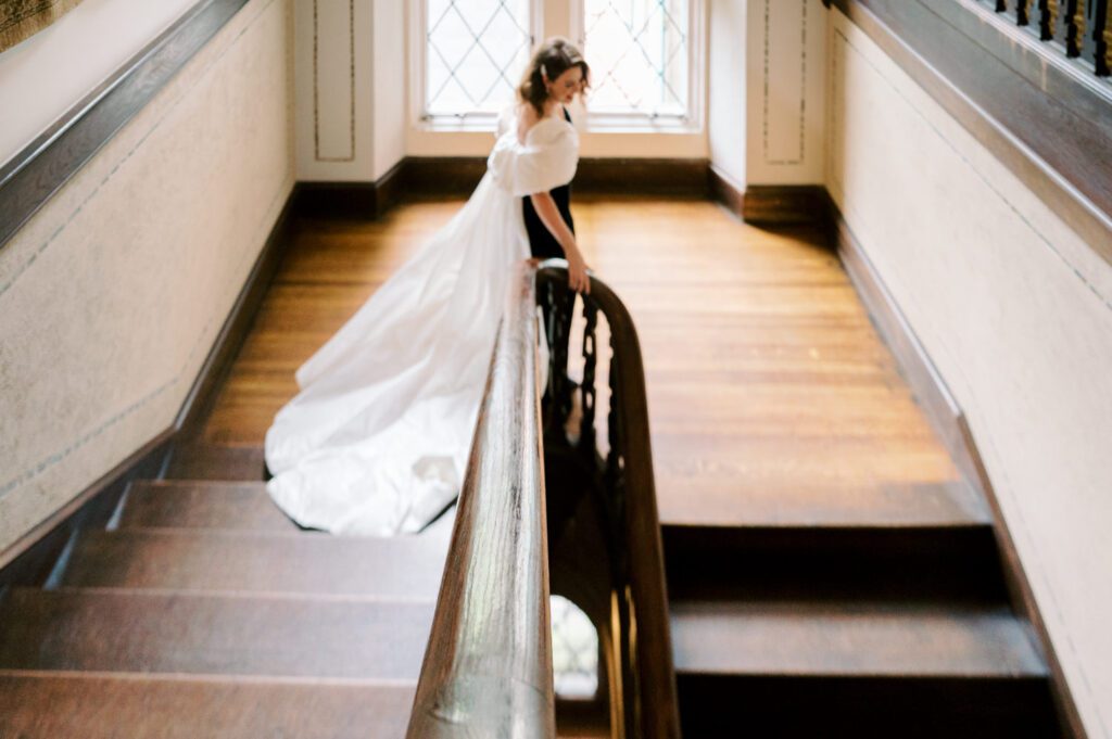 Kirsten and AJ’s September Wedding at Arrow Park, NY
Kirsten and AJ’s wedding day was a bit chilly and rainy, but their flexibility and positivity turned the day into a magical celebration. Originally planned for the garden, the ceremony was moved indoors due to the autumn rain. The staff at Arrow Park seamlessly transitioned the setup to the mansion’s main floor, creating an intimate and elegant ceremony space. The historic charm of the mansion, with its grand details and warm ambiance, added a cozy, romantic touch to their special day.
Kirsten, a talented fashion designer, surprised everyone—including her groom, AJ—by wearing a stunning black velvet strapless dress with an oversized white bow draping dramatically down the back. She designed the dress herself, and it was a show-stopper that perfectly reflected her unique style. The ceremony was heartfelt and personal, with family and friends gathering close to witness Kirsten and AJ’s vows.
After the ceremony, the main mansion was transformed to host a lively cocktail hour. Guests mingled and enjoyed delicious hors d'oeuvres while the reception space in the pavilion was being prepared. Kirsten and AJ’s attention to detail shone through in their décor choices, including the black-and-white checkered flooring that gave the pavilion a retro vibe. It was a perfect blend of modern chic and classic sophistication.
The reception began with Kirsten and AJ’s grand entrance, greeted by cheers from their guests. Their first dance was sweet and endearing, setting the tone for a night of joy and celebration. As the evening progressed, the party ramped up with enthusiastic dancing, heartfelt toasts, and even a surprise performance—a few uncles took the mic for an impromptu rap song that brought the house down.
Arrow Park provided the perfect backdrop for Kirsten and AJ’s wedding. With its blend of natural beauty and historic architecture, it’s an ideal venue for couples seeking a mix of indoor and outdoor spaces. The mansion offers a timeless elegance, while the pavilion provides a versatile setting for larger receptions.
Planning Tips for Future Couples at Arrow Park:
1. Have a Rain Plan: September weather can be unpredictable, so work with the Arrow Park staff to plan for both indoor and outdoor options. The mansion’s interiors provide a stunning alternative for ceremonies or cocktail hours.
2. Maximize the Pavilion: The pavilion’s spacious layout can accommodate various themes and setups. Consider unique flooring, lighting, or drapery to make the space your own.
3. Embrace the Venue’s Charm: Use the mansion’s historic features—like the fireplaces and vintage decor—as part of your wedding aesthetic. It’s a built-in backdrop that needs little embellishment.
4. Plan Time for Photos: Arrow Park’s grounds are breathtaking, especially in the fall. Schedule time with your photographer to capture the beauty of the lake, gardens, and mansion.
Kirsten and AJ’s wedding was a true testament to the power of creativity, adaptability, and love. Their celebration at Arrow Park was unforgettable, and I’m grateful to have been a part of their special day.
Thankful for all the wedding vendors that made this day possible:⁠
Venue: @arrowparkny
Catering: @lovenrosemary
Kirsten and AJ Arrow Park NY Wedding documented by Karis from Hey Karis New York, Brooklyn, Hudson Valley NY and Catskills NY and NJ Wedding and NYC Elopement Photographer.