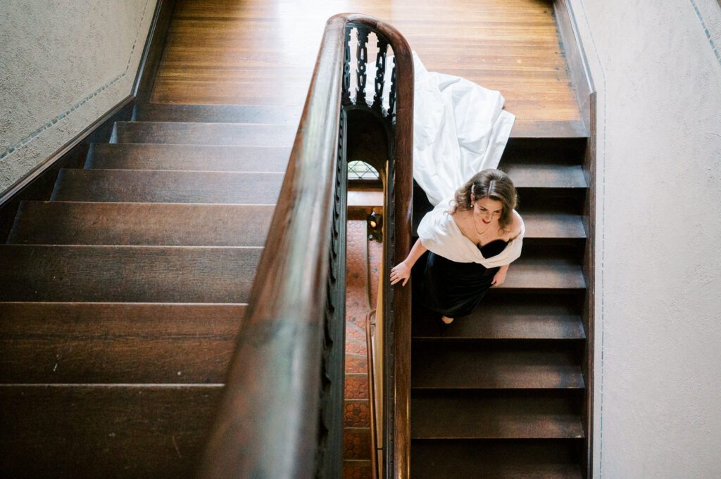 Kirsten and AJ’s September Wedding at Arrow Park, NY
Kirsten and AJ’s wedding day was a bit chilly and rainy, but their flexibility and positivity turned the day into a magical celebration. Originally planned for the garden, the ceremony was moved indoors due to the autumn rain. The staff at Arrow Park seamlessly transitioned the setup to the mansion’s main floor, creating an intimate and elegant ceremony space. The historic charm of the mansion, with its grand details and warm ambiance, added a cozy, romantic touch to their special day.
Kirsten, a talented fashion designer, surprised everyone—including her groom, AJ—by wearing a stunning black velvet strapless dress with an oversized white bow draping dramatically down the back. She designed the dress herself, and it was a show-stopper that perfectly reflected her unique style. The ceremony was heartfelt and personal, with family and friends gathering close to witness Kirsten and AJ’s vows.
After the ceremony, the main mansion was transformed to host a lively cocktail hour. Guests mingled and enjoyed delicious hors d'oeuvres while the reception space in the pavilion was being prepared. Kirsten and AJ’s attention to detail shone through in their décor choices, including the black-and-white checkered flooring that gave the pavilion a retro vibe. It was a perfect blend of modern chic and classic sophistication.
The reception began with Kirsten and AJ’s grand entrance, greeted by cheers from their guests. Their first dance was sweet and endearing, setting the tone for a night of joy and celebration. As the evening progressed, the party ramped up with enthusiastic dancing, heartfelt toasts, and even a surprise performance—a few uncles took the mic for an impromptu rap song that brought the house down.
Arrow Park provided the perfect backdrop for Kirsten and AJ’s wedding. With its blend of natural beauty and historic architecture, it’s an ideal venue for couples seeking a mix of indoor and outdoor spaces. The mansion offers a timeless elegance, while the pavilion provides a versatile setting for larger receptions.
Planning Tips for Future Couples at Arrow Park:
1. Have a Rain Plan: September weather can be unpredictable, so work with the Arrow Park staff to plan for both indoor and outdoor options. The mansion’s interiors provide a stunning alternative for ceremonies or cocktail hours.
2. Maximize the Pavilion: The pavilion’s spacious layout can accommodate various themes and setups. Consider unique flooring, lighting, or drapery to make the space your own.
3. Embrace the Venue’s Charm: Use the mansion’s historic features—like the fireplaces and vintage decor—as part of your wedding aesthetic. It’s a built-in backdrop that needs little embellishment.
4. Plan Time for Photos: Arrow Park’s grounds are breathtaking, especially in the fall. Schedule time with your photographer to capture the beauty of the lake, gardens, and mansion.
Kirsten and AJ’s wedding was a true testament to the power of creativity, adaptability, and love. Their celebration at Arrow Park was unforgettable, and I’m grateful to have been a part of their special day.
Thankful for all the wedding vendors that made this day possible:⁠
Venue: @arrowparkny
Catering: @lovenrosemary
Kirsten and AJ Arrow Park NY Wedding documented by Karis from Hey Karis New York, Brooklyn, Hudson Valley NY and Catskills NY and NJ Wedding and NYC Elopement Photographer.