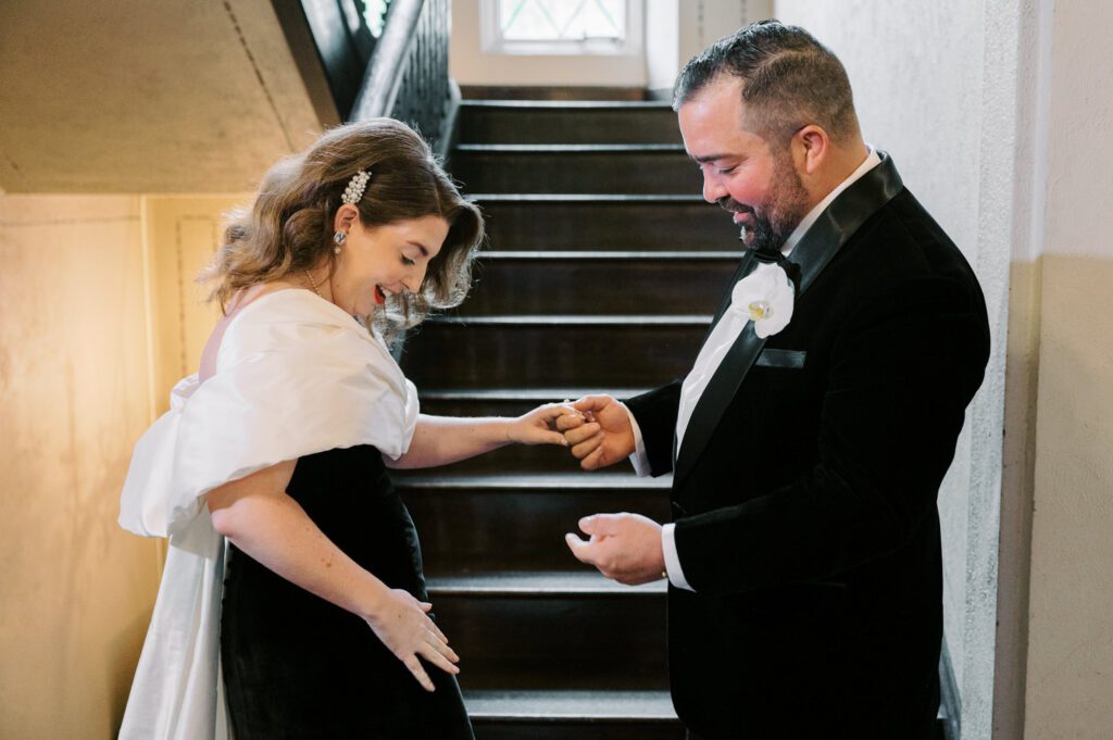 Kirsten and AJ’s September Wedding at Arrow Park, NY
Kirsten and AJ’s wedding day was a bit chilly and rainy, but their flexibility and positivity turned the day into a magical celebration. Originally planned for the garden, the ceremony was moved indoors due to the autumn rain. The staff at Arrow Park seamlessly transitioned the setup to the mansion’s main floor, creating an intimate and elegant ceremony space. The historic charm of the mansion, with its grand details and warm ambiance, added a cozy, romantic touch to their special day.
Kirsten, a talented fashion designer, surprised everyone—including her groom, AJ—by wearing a stunning black velvet strapless dress with an oversized white bow draping dramatically down the back. She designed the dress herself, and it was a show-stopper that perfectly reflected her unique style. The ceremony was heartfelt and personal, with family and friends gathering close to witness Kirsten and AJ’s vows.
After the ceremony, the main mansion was transformed to host a lively cocktail hour. Guests mingled and enjoyed delicious hors d'oeuvres while the reception space in the pavilion was being prepared. Kirsten and AJ’s attention to detail shone through in their décor choices, including the black-and-white checkered flooring that gave the pavilion a retro vibe. It was a perfect blend of modern chic and classic sophistication.
The reception began with Kirsten and AJ’s grand entrance, greeted by cheers from their guests. Their first dance was sweet and endearing, setting the tone for a night of joy and celebration. As the evening progressed, the party ramped up with enthusiastic dancing, heartfelt toasts, and even a surprise performance—a few uncles took the mic for an impromptu rap song that brought the house down.
Arrow Park provided the perfect backdrop for Kirsten and AJ’s wedding. With its blend of natural beauty and historic architecture, it’s an ideal venue for couples seeking a mix of indoor and outdoor spaces. The mansion offers a timeless elegance, while the pavilion provides a versatile setting for larger receptions.
Planning Tips for Future Couples at Arrow Park:
1. Have a Rain Plan: September weather can be unpredictable, so work with the Arrow Park staff to plan for both indoor and outdoor options. The mansion’s interiors provide a stunning alternative for ceremonies or cocktail hours.
2. Maximize the Pavilion: The pavilion’s spacious layout can accommodate various themes and setups. Consider unique flooring, lighting, or drapery to make the space your own.
3. Embrace the Venue’s Charm: Use the mansion’s historic features—like the fireplaces and vintage decor—as part of your wedding aesthetic. It’s a built-in backdrop that needs little embellishment.
4. Plan Time for Photos: Arrow Park’s grounds are breathtaking, especially in the fall. Schedule time with your photographer to capture the beauty of the lake, gardens, and mansion.
Kirsten and AJ’s wedding was a true testament to the power of creativity, adaptability, and love. Their celebration at Arrow Park was unforgettable, and I’m grateful to have been a part of their special day.
Thankful for all the wedding vendors that made this day possible:⁠
Venue: @arrowparkny
Catering: @lovenrosemary
Kirsten and AJ Arrow Park NY Wedding documented by Karis from Hey Karis New York, Brooklyn, Hudson Valley NY and Catskills NY and NJ Wedding and NYC Elopement Photographer.
