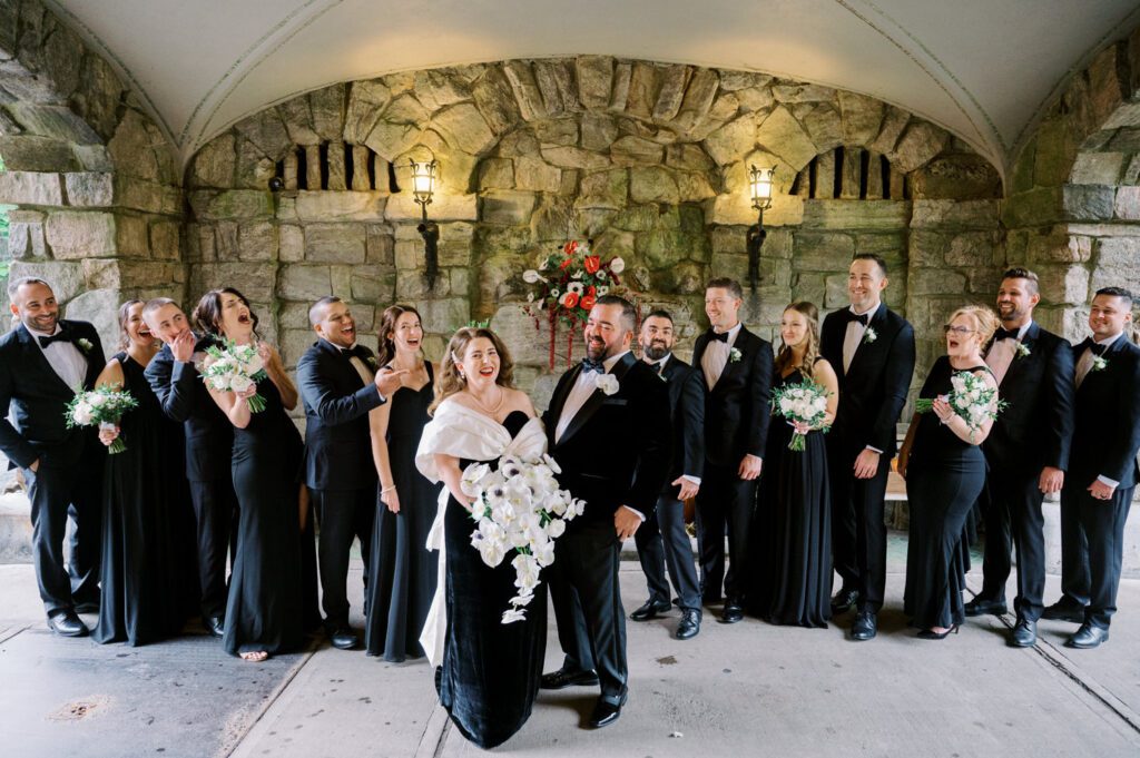 Kirsten and AJ’s September Wedding at Arrow Park, NY
Kirsten and AJ’s wedding day was a bit chilly and rainy, but their flexibility and positivity turned the day into a magical celebration. Originally planned for the garden, the ceremony was moved indoors due to the autumn rain. The staff at Arrow Park seamlessly transitioned the setup to the mansion’s main floor, creating an intimate and elegant ceremony space. The historic charm of the mansion, with its grand details and warm ambiance, added a cozy, romantic touch to their special day.
Kirsten, a talented fashion designer, surprised everyone—including her groom, AJ—by wearing a stunning black velvet strapless dress with an oversized white bow draping dramatically down the back. She designed the dress herself, and it was a show-stopper that perfectly reflected her unique style. The ceremony was heartfelt and personal, with family and friends gathering close to witness Kirsten and AJ’s vows.
After the ceremony, the main mansion was transformed to host a lively cocktail hour. Guests mingled and enjoyed delicious hors d'oeuvres while the reception space in the pavilion was being prepared. Kirsten and AJ’s attention to detail shone through in their décor choices, including the black-and-white checkered flooring that gave the pavilion a retro vibe. It was a perfect blend of modern chic and classic sophistication.
The reception began with Kirsten and AJ’s grand entrance, greeted by cheers from their guests. Their first dance was sweet and endearing, setting the tone for a night of joy and celebration. As the evening progressed, the party ramped up with enthusiastic dancing, heartfelt toasts, and even a surprise performance—a few uncles took the mic for an impromptu rap song that brought the house down.
Arrow Park provided the perfect backdrop for Kirsten and AJ’s wedding. With its blend of natural beauty and historic architecture, it’s an ideal venue for couples seeking a mix of indoor and outdoor spaces. The mansion offers a timeless elegance, while the pavilion provides a versatile setting for larger receptions.
Planning Tips for Future Couples at Arrow Park:
1. Have a Rain Plan: September weather can be unpredictable, so work with the Arrow Park staff to plan for both indoor and outdoor options. The mansion’s interiors provide a stunning alternative for ceremonies or cocktail hours.
2. Maximize the Pavilion: The pavilion’s spacious layout can accommodate various themes and setups. Consider unique flooring, lighting, or drapery to make the space your own.
3. Embrace the Venue’s Charm: Use the mansion’s historic features—like the fireplaces and vintage decor—as part of your wedding aesthetic. It’s a built-in backdrop that needs little embellishment.
4. Plan Time for Photos: Arrow Park’s grounds are breathtaking, especially in the fall. Schedule time with your photographer to capture the beauty of the lake, gardens, and mansion.
Kirsten and AJ’s wedding was a true testament to the power of creativity, adaptability, and love. Their celebration at Arrow Park was unforgettable, and I’m grateful to have been a part of their special day.
Thankful for all the wedding vendors that made this day possible:⁠
Venue: @arrowparkny
Catering: @lovenrosemary
Kirsten and AJ Arrow Park NY Wedding documented by Karis from Hey Karis New York, Brooklyn, Hudson Valley NY and Catskills NY and NJ Wedding and NYC Elopement Photographer.