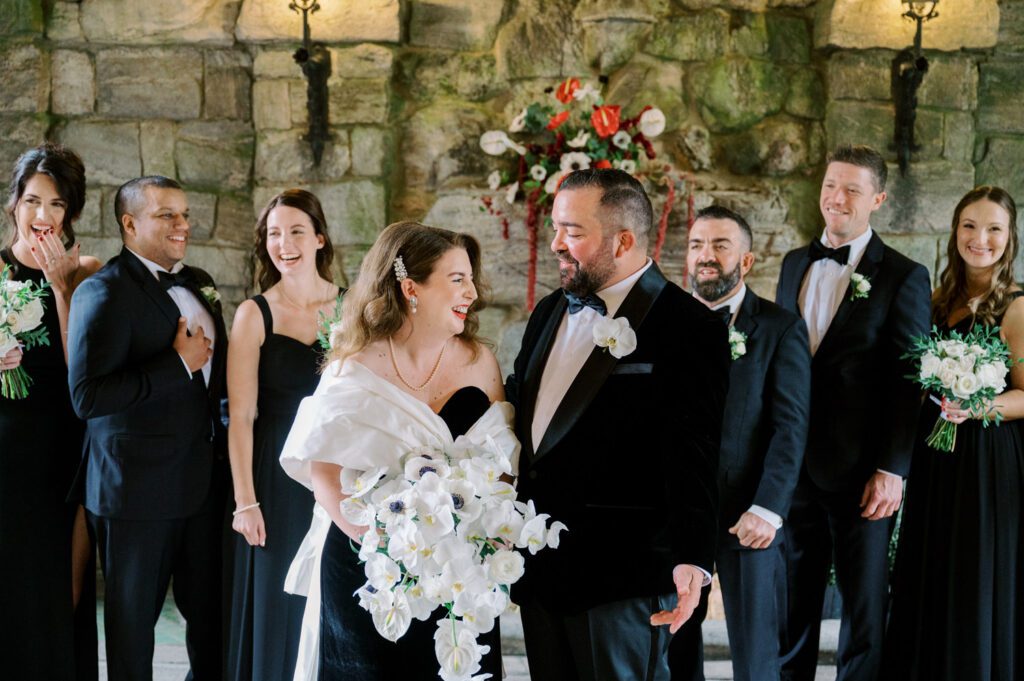 Kirsten and AJ’s September Wedding at Arrow Park, NY
Kirsten and AJ’s wedding day was a bit chilly and rainy, but their flexibility and positivity turned the day into a magical celebration. Originally planned for the garden, the ceremony was moved indoors due to the autumn rain. The staff at Arrow Park seamlessly transitioned the setup to the mansion’s main floor, creating an intimate and elegant ceremony space. The historic charm of the mansion, with its grand details and warm ambiance, added a cozy, romantic touch to their special day.
Kirsten, a talented fashion designer, surprised everyone—including her groom, AJ—by wearing a stunning black velvet strapless dress with an oversized white bow draping dramatically down the back. She designed the dress herself, and it was a show-stopper that perfectly reflected her unique style. The ceremony was heartfelt and personal, with family and friends gathering close to witness Kirsten and AJ’s vows.
After the ceremony, the main mansion was transformed to host a lively cocktail hour. Guests mingled and enjoyed delicious hors d'oeuvres while the reception space in the pavilion was being prepared. Kirsten and AJ’s attention to detail shone through in their décor choices, including the black-and-white checkered flooring that gave the pavilion a retro vibe. It was a perfect blend of modern chic and classic sophistication.
The reception began with Kirsten and AJ’s grand entrance, greeted by cheers from their guests. Their first dance was sweet and endearing, setting the tone for a night of joy and celebration. As the evening progressed, the party ramped up with enthusiastic dancing, heartfelt toasts, and even a surprise performance—a few uncles took the mic for an impromptu rap song that brought the house down.
Arrow Park provided the perfect backdrop for Kirsten and AJ’s wedding. With its blend of natural beauty and historic architecture, it’s an ideal venue for couples seeking a mix of indoor and outdoor spaces. The mansion offers a timeless elegance, while the pavilion provides a versatile setting for larger receptions.
Planning Tips for Future Couples at Arrow Park:
1. Have a Rain Plan: September weather can be unpredictable, so work with the Arrow Park staff to plan for both indoor and outdoor options. The mansion’s interiors provide a stunning alternative for ceremonies or cocktail hours.
2. Maximize the Pavilion: The pavilion’s spacious layout can accommodate various themes and setups. Consider unique flooring, lighting, or drapery to make the space your own.
3. Embrace the Venue’s Charm: Use the mansion’s historic features—like the fireplaces and vintage decor—as part of your wedding aesthetic. It’s a built-in backdrop that needs little embellishment.
4. Plan Time for Photos: Arrow Park’s grounds are breathtaking, especially in the fall. Schedule time with your photographer to capture the beauty of the lake, gardens, and mansion.
Kirsten and AJ’s wedding was a true testament to the power of creativity, adaptability, and love. Their celebration at Arrow Park was unforgettable, and I’m grateful to have been a part of their special day.
Thankful for all the wedding vendors that made this day possible:⁠
Venue: @arrowparkny
Catering: @lovenrosemary
Kirsten and AJ Arrow Park NY Wedding documented by Karis from Hey Karis New York, Brooklyn, Hudson Valley NY and Catskills NY and NJ Wedding and NYC Elopement Photographer.