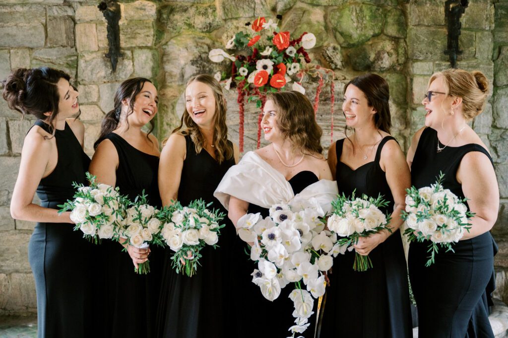 Kirsten and AJ’s September Wedding at Arrow Park, NY
Kirsten and AJ’s wedding day was a bit chilly and rainy, but their flexibility and positivity turned the day into a magical celebration. Originally planned for the garden, the ceremony was moved indoors due to the autumn rain. The staff at Arrow Park seamlessly transitioned the setup to the mansion’s main floor, creating an intimate and elegant ceremony space. The historic charm of the mansion, with its grand details and warm ambiance, added a cozy, romantic touch to their special day.
Kirsten, a talented fashion designer, surprised everyone—including her groom, AJ—by wearing a stunning black velvet strapless dress with an oversized white bow draping dramatically down the back. She designed the dress herself, and it was a show-stopper that perfectly reflected her unique style. The ceremony was heartfelt and personal, with family and friends gathering close to witness Kirsten and AJ’s vows.
After the ceremony, the main mansion was transformed to host a lively cocktail hour. Guests mingled and enjoyed delicious hors d'oeuvres while the reception space in the pavilion was being prepared. Kirsten and AJ’s attention to detail shone through in their décor choices, including the black-and-white checkered flooring that gave the pavilion a retro vibe. It was a perfect blend of modern chic and classic sophistication.
The reception began with Kirsten and AJ’s grand entrance, greeted by cheers from their guests. Their first dance was sweet and endearing, setting the tone for a night of joy and celebration. As the evening progressed, the party ramped up with enthusiastic dancing, heartfelt toasts, and even a surprise performance—a few uncles took the mic for an impromptu rap song that brought the house down.
Arrow Park provided the perfect backdrop for Kirsten and AJ’s wedding. With its blend of natural beauty and historic architecture, it’s an ideal venue for couples seeking a mix of indoor and outdoor spaces. The mansion offers a timeless elegance, while the pavilion provides a versatile setting for larger receptions.
Planning Tips for Future Couples at Arrow Park:
1. Have a Rain Plan: September weather can be unpredictable, so work with the Arrow Park staff to plan for both indoor and outdoor options. The mansion’s interiors provide a stunning alternative for ceremonies or cocktail hours.
2. Maximize the Pavilion: The pavilion’s spacious layout can accommodate various themes and setups. Consider unique flooring, lighting, or drapery to make the space your own.
3. Embrace the Venue’s Charm: Use the mansion’s historic features—like the fireplaces and vintage decor—as part of your wedding aesthetic. It’s a built-in backdrop that needs little embellishment.
4. Plan Time for Photos: Arrow Park’s grounds are breathtaking, especially in the fall. Schedule time with your photographer to capture the beauty of the lake, gardens, and mansion.
Kirsten and AJ’s wedding was a true testament to the power of creativity, adaptability, and love. Their celebration at Arrow Park was unforgettable, and I’m grateful to have been a part of their special day.
Thankful for all the wedding vendors that made this day possible:⁠
Venue: @arrowparkny
Catering: @lovenrosemary
Kirsten and AJ Arrow Park NY Wedding documented by Karis from Hey Karis New York, Brooklyn, Hudson Valley NY and Catskills NY and NJ Wedding and NYC Elopement Photographer.