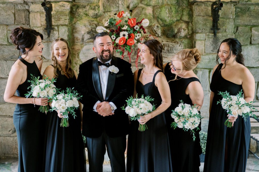 Kirsten and AJ’s September Wedding at Arrow Park, NY
Kirsten and AJ’s wedding day was a bit chilly and rainy, but their flexibility and positivity turned the day into a magical celebration. Originally planned for the garden, the ceremony was moved indoors due to the autumn rain. The staff at Arrow Park seamlessly transitioned the setup to the mansion’s main floor, creating an intimate and elegant ceremony space. The historic charm of the mansion, with its grand details and warm ambiance, added a cozy, romantic touch to their special day.
Kirsten, a talented fashion designer, surprised everyone—including her groom, AJ—by wearing a stunning black velvet strapless dress with an oversized white bow draping dramatically down the back. She designed the dress herself, and it was a show-stopper that perfectly reflected her unique style. The ceremony was heartfelt and personal, with family and friends gathering close to witness Kirsten and AJ’s vows.
After the ceremony, the main mansion was transformed to host a lively cocktail hour. Guests mingled and enjoyed delicious hors d'oeuvres while the reception space in the pavilion was being prepared. Kirsten and AJ’s attention to detail shone through in their décor choices, including the black-and-white checkered flooring that gave the pavilion a retro vibe. It was a perfect blend of modern chic and classic sophistication.
The reception began with Kirsten and AJ’s grand entrance, greeted by cheers from their guests. Their first dance was sweet and endearing, setting the tone for a night of joy and celebration. As the evening progressed, the party ramped up with enthusiastic dancing, heartfelt toasts, and even a surprise performance—a few uncles took the mic for an impromptu rap song that brought the house down.
Arrow Park provided the perfect backdrop for Kirsten and AJ’s wedding. With its blend of natural beauty and historic architecture, it’s an ideal venue for couples seeking a mix of indoor and outdoor spaces. The mansion offers a timeless elegance, while the pavilion provides a versatile setting for larger receptions.
Planning Tips for Future Couples at Arrow Park:
1. Have a Rain Plan: September weather can be unpredictable, so work with the Arrow Park staff to plan for both indoor and outdoor options. The mansion’s interiors provide a stunning alternative for ceremonies or cocktail hours.
2. Maximize the Pavilion: The pavilion’s spacious layout can accommodate various themes and setups. Consider unique flooring, lighting, or drapery to make the space your own.
3. Embrace the Venue’s Charm: Use the mansion’s historic features—like the fireplaces and vintage decor—as part of your wedding aesthetic. It’s a built-in backdrop that needs little embellishment.
4. Plan Time for Photos: Arrow Park’s grounds are breathtaking, especially in the fall. Schedule time with your photographer to capture the beauty of the lake, gardens, and mansion.
Kirsten and AJ’s wedding was a true testament to the power of creativity, adaptability, and love. Their celebration at Arrow Park was unforgettable, and I’m grateful to have been a part of their special day.
Thankful for all the wedding vendors that made this day possible:⁠
Venue: @arrowparkny
Catering: @lovenrosemary
Kirsten and AJ Arrow Park NY Wedding documented by Karis from Hey Karis New York, Brooklyn, Hudson Valley NY and Catskills NY and NJ Wedding and NYC Elopement Photographer.