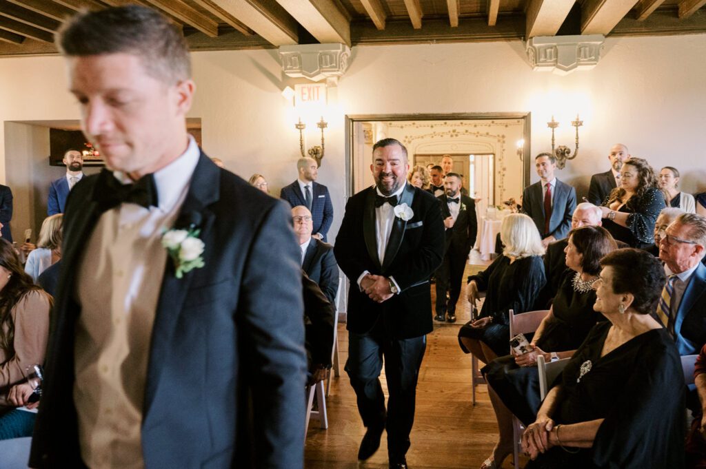 Kirsten and AJ’s September Wedding at Arrow Park, NY
Kirsten and AJ’s wedding day was a bit chilly and rainy, but their flexibility and positivity turned the day into a magical celebration. Originally planned for the garden, the ceremony was moved indoors due to the autumn rain. The staff at Arrow Park seamlessly transitioned the setup to the mansion’s main floor, creating an intimate and elegant ceremony space. The historic charm of the mansion, with its grand details and warm ambiance, added a cozy, romantic touch to their special day.
Kirsten, a talented fashion designer, surprised everyone—including her groom, AJ—by wearing a stunning black velvet strapless dress with an oversized white bow draping dramatically down the back. She designed the dress herself, and it was a show-stopper that perfectly reflected her unique style. The ceremony was heartfelt and personal, with family and friends gathering close to witness Kirsten and AJ’s vows.
After the ceremony, the main mansion was transformed to host a lively cocktail hour. Guests mingled and enjoyed delicious hors d'oeuvres while the reception space in the pavilion was being prepared. Kirsten and AJ’s attention to detail shone through in their décor choices, including the black-and-white checkered flooring that gave the pavilion a retro vibe. It was a perfect blend of modern chic and classic sophistication.
The reception began with Kirsten and AJ’s grand entrance, greeted by cheers from their guests. Their first dance was sweet and endearing, setting the tone for a night of joy and celebration. As the evening progressed, the party ramped up with enthusiastic dancing, heartfelt toasts, and even a surprise performance—a few uncles took the mic for an impromptu rap song that brought the house down.
Arrow Park provided the perfect backdrop for Kirsten and AJ’s wedding. With its blend of natural beauty and historic architecture, it’s an ideal venue for couples seeking a mix of indoor and outdoor spaces. The mansion offers a timeless elegance, while the pavilion provides a versatile setting for larger receptions.
Planning Tips for Future Couples at Arrow Park:
1. Have a Rain Plan: September weather can be unpredictable, so work with the Arrow Park staff to plan for both indoor and outdoor options. The mansion’s interiors provide a stunning alternative for ceremonies or cocktail hours.
2. Maximize the Pavilion: The pavilion’s spacious layout can accommodate various themes and setups. Consider unique flooring, lighting, or drapery to make the space your own.
3. Embrace the Venue’s Charm: Use the mansion’s historic features—like the fireplaces and vintage decor—as part of your wedding aesthetic. It’s a built-in backdrop that needs little embellishment.
4. Plan Time for Photos: Arrow Park’s grounds are breathtaking, especially in the fall. Schedule time with your photographer to capture the beauty of the lake, gardens, and mansion.
Kirsten and AJ’s wedding was a true testament to the power of creativity, adaptability, and love. Their celebration at Arrow Park was unforgettable, and I’m grateful to have been a part of their special day.
Thankful for all the wedding vendors that made this day possible:⁠
Venue: @arrowparkny
Catering: @lovenrosemary
Kirsten and AJ Arrow Park NY Wedding documented by Karis from Hey Karis New York, Brooklyn, Hudson Valley NY and Catskills NY and NJ Wedding and NYC Elopement Photographer.