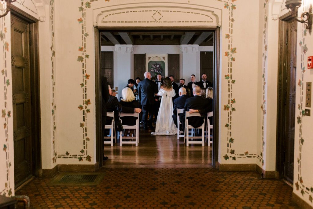 Kirsten and AJ’s September Wedding at Arrow Park, NY
Kirsten and AJ’s wedding day was a bit chilly and rainy, but their flexibility and positivity turned the day into a magical celebration. Originally planned for the garden, the ceremony was moved indoors due to the autumn rain. The staff at Arrow Park seamlessly transitioned the setup to the mansion’s main floor, creating an intimate and elegant ceremony space. The historic charm of the mansion, with its grand details and warm ambiance, added a cozy, romantic touch to their special day.
Kirsten, a talented fashion designer, surprised everyone—including her groom, AJ—by wearing a stunning black velvet strapless dress with an oversized white bow draping dramatically down the back. She designed the dress herself, and it was a show-stopper that perfectly reflected her unique style. The ceremony was heartfelt and personal, with family and friends gathering close to witness Kirsten and AJ’s vows.
After the ceremony, the main mansion was transformed to host a lively cocktail hour. Guests mingled and enjoyed delicious hors d'oeuvres while the reception space in the pavilion was being prepared. Kirsten and AJ’s attention to detail shone through in their décor choices, including the black-and-white checkered flooring that gave the pavilion a retro vibe. It was a perfect blend of modern chic and classic sophistication.
The reception began with Kirsten and AJ’s grand entrance, greeted by cheers from their guests. Their first dance was sweet and endearing, setting the tone for a night of joy and celebration. As the evening progressed, the party ramped up with enthusiastic dancing, heartfelt toasts, and even a surprise performance—a few uncles took the mic for an impromptu rap song that brought the house down.
Arrow Park provided the perfect backdrop for Kirsten and AJ’s wedding. With its blend of natural beauty and historic architecture, it’s an ideal venue for couples seeking a mix of indoor and outdoor spaces. The mansion offers a timeless elegance, while the pavilion provides a versatile setting for larger receptions.
Planning Tips for Future Couples at Arrow Park:
1. Have a Rain Plan: September weather can be unpredictable, so work with the Arrow Park staff to plan for both indoor and outdoor options. The mansion’s interiors provide a stunning alternative for ceremonies or cocktail hours.
2. Maximize the Pavilion: The pavilion’s spacious layout can accommodate various themes and setups. Consider unique flooring, lighting, or drapery to make the space your own.
3. Embrace the Venue’s Charm: Use the mansion’s historic features—like the fireplaces and vintage decor—as part of your wedding aesthetic. It’s a built-in backdrop that needs little embellishment.
4. Plan Time for Photos: Arrow Park’s grounds are breathtaking, especially in the fall. Schedule time with your photographer to capture the beauty of the lake, gardens, and mansion.
Kirsten and AJ’s wedding was a true testament to the power of creativity, adaptability, and love. Their celebration at Arrow Park was unforgettable, and I’m grateful to have been a part of their special day.
Thankful for all the wedding vendors that made this day possible:⁠
Venue: @arrowparkny
Catering: @lovenrosemary
Kirsten and AJ Arrow Park NY Wedding documented by Karis from Hey Karis New York, Brooklyn, Hudson Valley NY and Catskills NY and NJ Wedding and NYC Elopement Photographer.