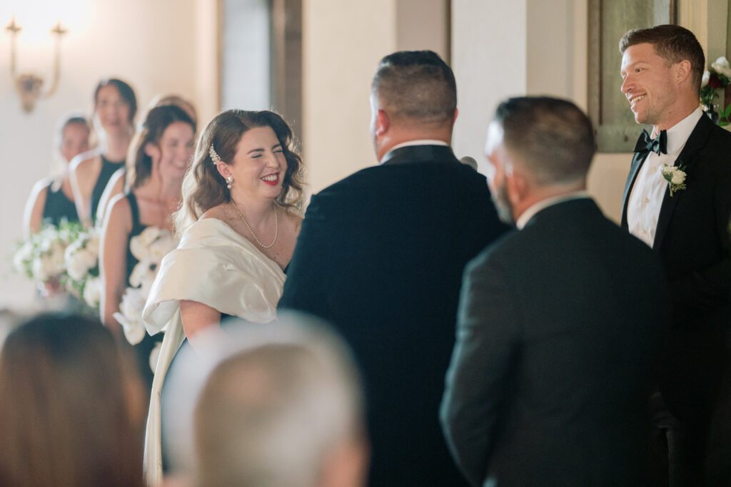 Kirsten and AJ’s September Wedding at Arrow Park, NY
Kirsten and AJ’s wedding day was a bit chilly and rainy, but their flexibility and positivity turned the day into a magical celebration. Originally planned for the garden, the ceremony was moved indoors due to the autumn rain. The staff at Arrow Park seamlessly transitioned the setup to the mansion’s main floor, creating an intimate and elegant ceremony space. The historic charm of the mansion, with its grand details and warm ambiance, added a cozy, romantic touch to their special day.
Kirsten, a talented fashion designer, surprised everyone—including her groom, AJ—by wearing a stunning black velvet strapless dress with an oversized white bow draping dramatically down the back. She designed the dress herself, and it was a show-stopper that perfectly reflected her unique style. The ceremony was heartfelt and personal, with family and friends gathering close to witness Kirsten and AJ’s vows.
After the ceremony, the main mansion was transformed to host a lively cocktail hour. Guests mingled and enjoyed delicious hors d'oeuvres while the reception space in the pavilion was being prepared. Kirsten and AJ’s attention to detail shone through in their décor choices, including the black-and-white checkered flooring that gave the pavilion a retro vibe. It was a perfect blend of modern chic and classic sophistication.
The reception began with Kirsten and AJ’s grand entrance, greeted by cheers from their guests. Their first dance was sweet and endearing, setting the tone for a night of joy and celebration. As the evening progressed, the party ramped up with enthusiastic dancing, heartfelt toasts, and even a surprise performance—a few uncles took the mic for an impromptu rap song that brought the house down.
Arrow Park provided the perfect backdrop for Kirsten and AJ’s wedding. With its blend of natural beauty and historic architecture, it’s an ideal venue for couples seeking a mix of indoor and outdoor spaces. The mansion offers a timeless elegance, while the pavilion provides a versatile setting for larger receptions.
Planning Tips for Future Couples at Arrow Park:
1. Have a Rain Plan: September weather can be unpredictable, so work with the Arrow Park staff to plan for both indoor and outdoor options. The mansion’s interiors provide a stunning alternative for ceremonies or cocktail hours.
2. Maximize the Pavilion: The pavilion’s spacious layout can accommodate various themes and setups. Consider unique flooring, lighting, or drapery to make the space your own.
3. Embrace the Venue’s Charm: Use the mansion’s historic features—like the fireplaces and vintage decor—as part of your wedding aesthetic. It’s a built-in backdrop that needs little embellishment.
4. Plan Time for Photos: Arrow Park’s grounds are breathtaking, especially in the fall. Schedule time with your photographer to capture the beauty of the lake, gardens, and mansion.
Kirsten and AJ’s wedding was a true testament to the power of creativity, adaptability, and love. Their celebration at Arrow Park was unforgettable, and I’m grateful to have been a part of their special day.
Thankful for all the wedding vendors that made this day possible:⁠
Venue: @arrowparkny
Catering: @lovenrosemary
Kirsten and AJ Arrow Park NY Wedding documented by Karis from Hey Karis New York, Brooklyn, Hudson Valley NY and Catskills NY and NJ Wedding and NYC Elopement Photographer.