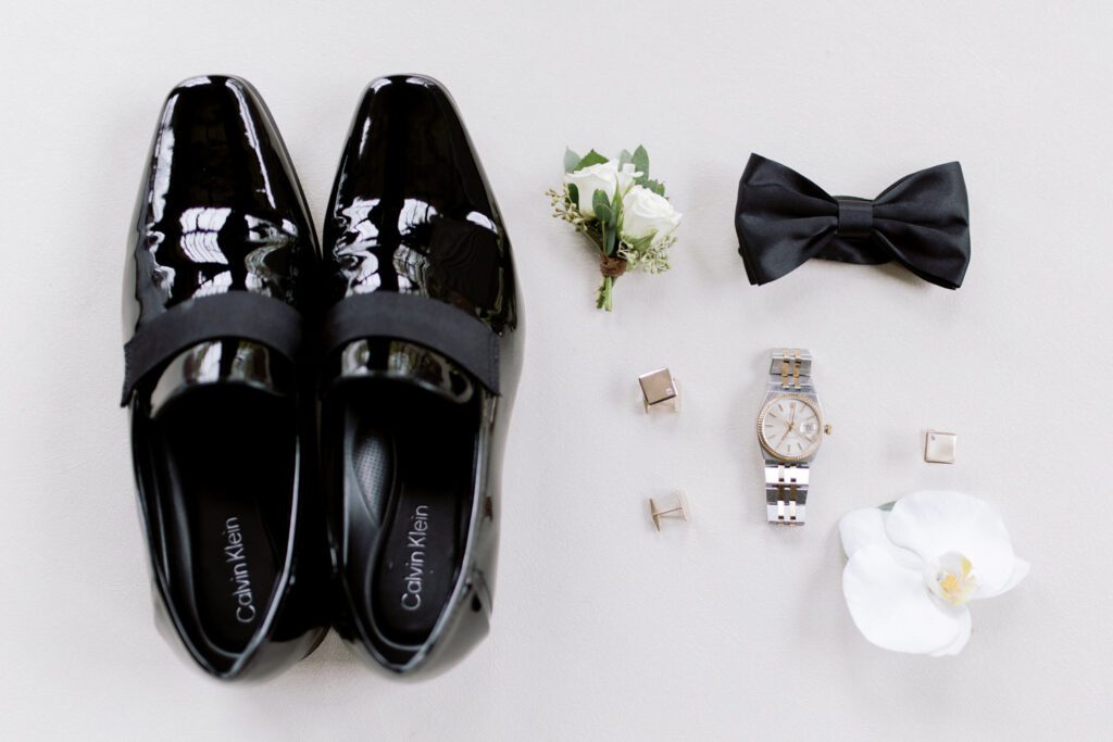 Kirsten and AJ’s September Wedding at Arrow Park, NY
Kirsten and AJ’s wedding day was a bit chilly and rainy, but their flexibility and positivity turned the day into a magical celebration. Originally planned for the garden, the ceremony was moved indoors due to the autumn rain. The staff at Arrow Park seamlessly transitioned the setup to the mansion’s main floor, creating an intimate and elegant ceremony space. The historic charm of the mansion, with its grand details and warm ambiance, added a cozy, romantic touch to their special day.
Kirsten, a talented fashion designer, surprised everyone—including her groom, AJ—by wearing a stunning black velvet strapless dress with an oversized white bow draping dramatically down the back. She designed the dress herself, and it was a show-stopper that perfectly reflected her unique style. The ceremony was heartfelt and personal, with family and friends gathering close to witness Kirsten and AJ’s vows.
After the ceremony, the main mansion was transformed to host a lively cocktail hour. Guests mingled and enjoyed delicious hors d'oeuvres while the reception space in the pavilion was being prepared. Kirsten and AJ’s attention to detail shone through in their décor choices, including the black-and-white checkered flooring that gave the pavilion a retro vibe. It was a perfect blend of modern chic and classic sophistication.
The reception began with Kirsten and AJ’s grand entrance, greeted by cheers from their guests. Their first dance was sweet and endearing, setting the tone for a night of joy and celebration. As the evening progressed, the party ramped up with enthusiastic dancing, heartfelt toasts, and even a surprise performance—a few uncles took the mic for an impromptu rap song that brought the house down.
Arrow Park provided the perfect backdrop for Kirsten and AJ’s wedding. With its blend of natural beauty and historic architecture, it’s an ideal venue for couples seeking a mix of indoor and outdoor spaces. The mansion offers a timeless elegance, while the pavilion provides a versatile setting for larger receptions.
Planning Tips for Future Couples at Arrow Park:
1. Have a Rain Plan: September weather can be unpredictable, so work with the Arrow Park staff to plan for both indoor and outdoor options. The mansion’s interiors provide a stunning alternative for ceremonies or cocktail hours.
2. Maximize the Pavilion: The pavilion’s spacious layout can accommodate various themes and setups. Consider unique flooring, lighting, or drapery to make the space your own.
3. Embrace the Venue’s Charm: Use the mansion’s historic features—like the fireplaces and vintage decor—as part of your wedding aesthetic. It’s a built-in backdrop that needs little embellishment.
4. Plan Time for Photos: Arrow Park’s grounds are breathtaking, especially in the fall. Schedule time with your photographer to capture the beauty of the lake, gardens, and mansion.
Kirsten and AJ’s wedding was a true testament to the power of creativity, adaptability, and love. Their celebration at Arrow Park was unforgettable, and I’m grateful to have been a part of their special day.
Thankful for all the wedding vendors that made this day possible:⁠
Venue: @arrowparkny
Catering: @lovenrosemary
Kirsten and AJ Arrow Park NY Wedding documented by Karis from Hey Karis New York, Brooklyn, Hudson Valley NY and Catskills NY and NJ Wedding and NYC Elopement Photographer.