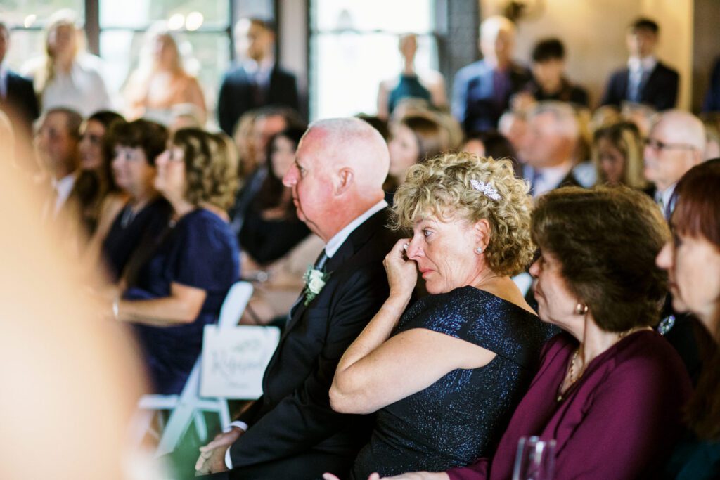 Kirsten and AJ’s September Wedding at Arrow Park, NY
Kirsten and AJ’s wedding day was a bit chilly and rainy, but their flexibility and positivity turned the day into a magical celebration. Originally planned for the garden, the ceremony was moved indoors due to the autumn rain. The staff at Arrow Park seamlessly transitioned the setup to the mansion’s main floor, creating an intimate and elegant ceremony space. The historic charm of the mansion, with its grand details and warm ambiance, added a cozy, romantic touch to their special day.
Kirsten, a talented fashion designer, surprised everyone—including her groom, AJ—by wearing a stunning black velvet strapless dress with an oversized white bow draping dramatically down the back. She designed the dress herself, and it was a show-stopper that perfectly reflected her unique style. The ceremony was heartfelt and personal, with family and friends gathering close to witness Kirsten and AJ’s vows.
After the ceremony, the main mansion was transformed to host a lively cocktail hour. Guests mingled and enjoyed delicious hors d'oeuvres while the reception space in the pavilion was being prepared. Kirsten and AJ’s attention to detail shone through in their décor choices, including the black-and-white checkered flooring that gave the pavilion a retro vibe. It was a perfect blend of modern chic and classic sophistication.
The reception began with Kirsten and AJ’s grand entrance, greeted by cheers from their guests. Their first dance was sweet and endearing, setting the tone for a night of joy and celebration. As the evening progressed, the party ramped up with enthusiastic dancing, heartfelt toasts, and even a surprise performance—a few uncles took the mic for an impromptu rap song that brought the house down.
Arrow Park provided the perfect backdrop for Kirsten and AJ’s wedding. With its blend of natural beauty and historic architecture, it’s an ideal venue for couples seeking a mix of indoor and outdoor spaces. The mansion offers a timeless elegance, while the pavilion provides a versatile setting for larger receptions.
Planning Tips for Future Couples at Arrow Park:
1. Have a Rain Plan: September weather can be unpredictable, so work with the Arrow Park staff to plan for both indoor and outdoor options. The mansion’s interiors provide a stunning alternative for ceremonies or cocktail hours.
2. Maximize the Pavilion: The pavilion’s spacious layout can accommodate various themes and setups. Consider unique flooring, lighting, or drapery to make the space your own.
3. Embrace the Venue’s Charm: Use the mansion’s historic features—like the fireplaces and vintage decor—as part of your wedding aesthetic. It’s a built-in backdrop that needs little embellishment.
4. Plan Time for Photos: Arrow Park’s grounds are breathtaking, especially in the fall. Schedule time with your photographer to capture the beauty of the lake, gardens, and mansion.
Kirsten and AJ’s wedding was a true testament to the power of creativity, adaptability, and love. Their celebration at Arrow Park was unforgettable, and I’m grateful to have been a part of their special day.
Thankful for all the wedding vendors that made this day possible:⁠
Venue: @arrowparkny
Catering: @lovenrosemary
Kirsten and AJ Arrow Park NY Wedding documented by Karis from Hey Karis New York, Brooklyn, Hudson Valley NY and Catskills NY and NJ Wedding and NYC Elopement Photographer.