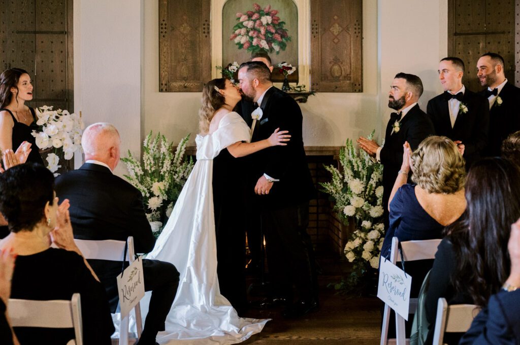 Kirsten and AJ’s September Wedding at Arrow Park, NY
Kirsten and AJ’s wedding day was a bit chilly and rainy, but their flexibility and positivity turned the day into a magical celebration. Originally planned for the garden, the ceremony was moved indoors due to the autumn rain. The staff at Arrow Park seamlessly transitioned the setup to the mansion’s main floor, creating an intimate and elegant ceremony space. The historic charm of the mansion, with its grand details and warm ambiance, added a cozy, romantic touch to their special day.
Kirsten, a talented fashion designer, surprised everyone—including her groom, AJ—by wearing a stunning black velvet strapless dress with an oversized white bow draping dramatically down the back. She designed the dress herself, and it was a show-stopper that perfectly reflected her unique style. The ceremony was heartfelt and personal, with family and friends gathering close to witness Kirsten and AJ’s vows.
After the ceremony, the main mansion was transformed to host a lively cocktail hour. Guests mingled and enjoyed delicious hors d'oeuvres while the reception space in the pavilion was being prepared. Kirsten and AJ’s attention to detail shone through in their décor choices, including the black-and-white checkered flooring that gave the pavilion a retro vibe. It was a perfect blend of modern chic and classic sophistication.
The reception began with Kirsten and AJ’s grand entrance, greeted by cheers from their guests. Their first dance was sweet and endearing, setting the tone for a night of joy and celebration. As the evening progressed, the party ramped up with enthusiastic dancing, heartfelt toasts, and even a surprise performance—a few uncles took the mic for an impromptu rap song that brought the house down.
Arrow Park provided the perfect backdrop for Kirsten and AJ’s wedding. With its blend of natural beauty and historic architecture, it’s an ideal venue for couples seeking a mix of indoor and outdoor spaces. The mansion offers a timeless elegance, while the pavilion provides a versatile setting for larger receptions.
Planning Tips for Future Couples at Arrow Park:
1. Have a Rain Plan: September weather can be unpredictable, so work with the Arrow Park staff to plan for both indoor and outdoor options. The mansion’s interiors provide a stunning alternative for ceremonies or cocktail hours.
2. Maximize the Pavilion: The pavilion’s spacious layout can accommodate various themes and setups. Consider unique flooring, lighting, or drapery to make the space your own.
3. Embrace the Venue’s Charm: Use the mansion’s historic features—like the fireplaces and vintage decor—as part of your wedding aesthetic. It’s a built-in backdrop that needs little embellishment.
4. Plan Time for Photos: Arrow Park’s grounds are breathtaking, especially in the fall. Schedule time with your photographer to capture the beauty of the lake, gardens, and mansion.
Kirsten and AJ’s wedding was a true testament to the power of creativity, adaptability, and love. Their celebration at Arrow Park was unforgettable, and I’m grateful to have been a part of their special day.
Thankful for all the wedding vendors that made this day possible:⁠
Venue: @arrowparkny
Catering: @lovenrosemary
Kirsten and AJ Arrow Park NY Wedding documented by Karis from Hey Karis New York, Brooklyn, Hudson Valley NY and Catskills NY and NJ Wedding and NYC Elopement Photographer.