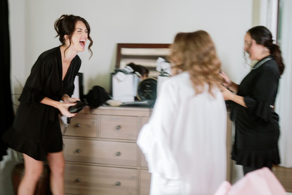 Kirsten and AJ’s September Wedding at Arrow Park, NY
Kirsten and AJ’s wedding day was a bit chilly and rainy, but their flexibility and positivity turned the day into a magical celebration. Originally planned for the garden, the ceremony was moved indoors due to the autumn rain. The staff at Arrow Park seamlessly transitioned the setup to the mansion’s main floor, creating an intimate and elegant ceremony space. The historic charm of the mansion, with its grand details and warm ambiance, added a cozy, romantic touch to their special day.
Kirsten, a talented fashion designer, surprised everyone—including her groom, AJ—by wearing a stunning black velvet strapless dress with an oversized white bow draping dramatically down the back. She designed the dress herself, and it was a show-stopper that perfectly reflected her unique style. The ceremony was heartfelt and personal, with family and friends gathering close to witness Kirsten and AJ’s vows.
After the ceremony, the main mansion was transformed to host a lively cocktail hour. Guests mingled and enjoyed delicious hors d'oeuvres while the reception space in the pavilion was being prepared. Kirsten and AJ’s attention to detail shone through in their décor choices, including the black-and-white checkered flooring that gave the pavilion a retro vibe. It was a perfect blend of modern chic and classic sophistication.
The reception began with Kirsten and AJ’s grand entrance, greeted by cheers from their guests. Their first dance was sweet and endearing, setting the tone for a night of joy and celebration. As the evening progressed, the party ramped up with enthusiastic dancing, heartfelt toasts, and even a surprise performance—a few uncles took the mic for an impromptu rap song that brought the house down.
Arrow Park provided the perfect backdrop for Kirsten and AJ’s wedding. With its blend of natural beauty and historic architecture, it’s an ideal venue for couples seeking a mix of indoor and outdoor spaces. The mansion offers a timeless elegance, while the pavilion provides a versatile setting for larger receptions.
Planning Tips for Future Couples at Arrow Park:
1. Have a Rain Plan: September weather can be unpredictable, so work with the Arrow Park staff to plan for both indoor and outdoor options. The mansion’s interiors provide a stunning alternative for ceremonies or cocktail hours.
2. Maximize the Pavilion: The pavilion’s spacious layout can accommodate various themes and setups. Consider unique flooring, lighting, or drapery to make the space your own.
3. Embrace the Venue’s Charm: Use the mansion’s historic features—like the fireplaces and vintage decor—as part of your wedding aesthetic. It’s a built-in backdrop that needs little embellishment.
4. Plan Time for Photos: Arrow Park’s grounds are breathtaking, especially in the fall. Schedule time with your photographer to capture the beauty of the lake, gardens, and mansion.
Kirsten and AJ’s wedding was a true testament to the power of creativity, adaptability, and love. Their celebration at Arrow Park was unforgettable, and I’m grateful to have been a part of their special day.
Thankful for all the wedding vendors that made this day possible:⁠
Venue: @arrowparkny
Catering: @lovenrosemary
Kirsten and AJ Arrow Park NY Wedding documented by Karis from Hey Karis New York, Brooklyn, Hudson Valley NY and Catskills NY and NJ Wedding and NYC Elopement Photographer.