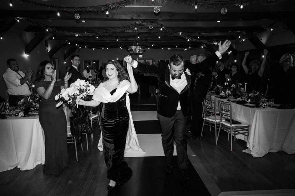 Kirsten and AJ’s September Wedding at Arrow Park, NY
Kirsten and AJ’s wedding day was a bit chilly and rainy, but their flexibility and positivity turned the day into a magical celebration. Originally planned for the garden, the ceremony was moved indoors due to the autumn rain. The staff at Arrow Park seamlessly transitioned the setup to the mansion’s main floor, creating an intimate and elegant ceremony space. The historic charm of the mansion, with its grand details and warm ambiance, added a cozy, romantic touch to their special day.
Kirsten, a talented fashion designer, surprised everyone—including her groom, AJ—by wearing a stunning black velvet strapless dress with an oversized white bow draping dramatically down the back. She designed the dress herself, and it was a show-stopper that perfectly reflected her unique style. The ceremony was heartfelt and personal, with family and friends gathering close to witness Kirsten and AJ’s vows.
After the ceremony, the main mansion was transformed to host a lively cocktail hour. Guests mingled and enjoyed delicious hors d'oeuvres while the reception space in the pavilion was being prepared. Kirsten and AJ’s attention to detail shone through in their décor choices, including the black-and-white checkered flooring that gave the pavilion a retro vibe. It was a perfect blend of modern chic and classic sophistication.
The reception began with Kirsten and AJ’s grand entrance, greeted by cheers from their guests. Their first dance was sweet and endearing, setting the tone for a night of joy and celebration. As the evening progressed, the party ramped up with enthusiastic dancing, heartfelt toasts, and even a surprise performance—a few uncles took the mic for an impromptu rap song that brought the house down.
Arrow Park provided the perfect backdrop for Kirsten and AJ’s wedding. With its blend of natural beauty and historic architecture, it’s an ideal venue for couples seeking a mix of indoor and outdoor spaces. The mansion offers a timeless elegance, while the pavilion provides a versatile setting for larger receptions.
Planning Tips for Future Couples at Arrow Park:
1. Have a Rain Plan: September weather can be unpredictable, so work with the Arrow Park staff to plan for both indoor and outdoor options. The mansion’s interiors provide a stunning alternative for ceremonies or cocktail hours.
2. Maximize the Pavilion: The pavilion’s spacious layout can accommodate various themes and setups. Consider unique flooring, lighting, or drapery to make the space your own.
3. Embrace the Venue’s Charm: Use the mansion’s historic features—like the fireplaces and vintage decor—as part of your wedding aesthetic. It’s a built-in backdrop that needs little embellishment.
4. Plan Time for Photos: Arrow Park’s grounds are breathtaking, especially in the fall. Schedule time with your photographer to capture the beauty of the lake, gardens, and mansion.
Kirsten and AJ’s wedding was a true testament to the power of creativity, adaptability, and love. Their celebration at Arrow Park was unforgettable, and I’m grateful to have been a part of their special day.
Thankful for all the wedding vendors that made this day possible:⁠
Venue: @arrowparkny
Catering: @lovenrosemary
Kirsten and AJ Arrow Park NY Wedding documented by Karis from Hey Karis New York, Brooklyn, Hudson Valley NY and Catskills NY and NJ Wedding and NYC Elopement Photographer.