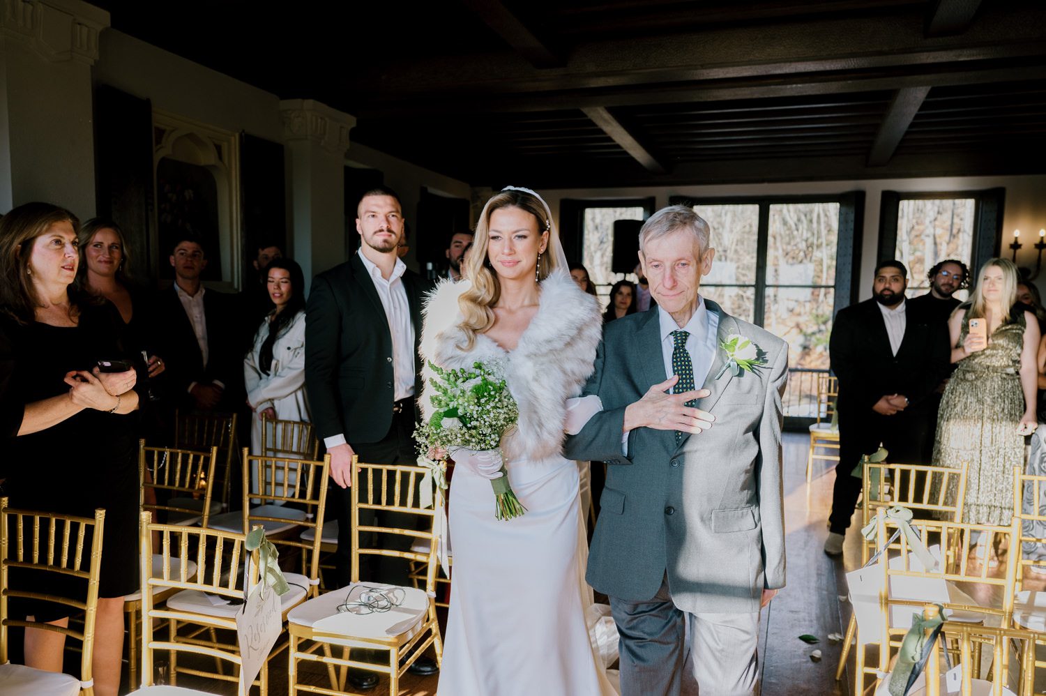 Kelsey and Liron Winter Wedding at Arrow Park, NY
My first wedding at Arrow Park was back in June 2022 when I had the pleasure of photographing Jackie and Aron’s wedding. From that moment, other wedding inquiries and opportunities arose, allowing me to capture the love stories of more wonderful couples at Arrow Park. That’s how I met Kelsey. Kelsey is the sales manager at Arrow Park, and since then, she has been a fan of my work. When it came time to plan her own wedding, I was delighted and honored that she chose me to document her beautiful celebration at Arrow Park.
Kelsey was well-prepared for the chilly weather, as she was getting married in December, so the wedding took place inside the mansion. When I arrived, Kelsey was finishing up her hair and makeup, just about ready to put on her dress. Families started to arrive, filling the space with warm greetings and laughter—one of my favorite scenes to witness on a wedding morning. Kelsey stepped into her dress, slipped on her gloves, and completed her final wedding preparations. She sparkled even more than the diamond on her finger as she walked over to see her groom.
As Kelsey walked down the aisle escorted by her father, emotions filled the room. Tears welled up in the eyes of their family and friends while Liron stood at the altar, watching her with a big smile. With their loved ones witnessing, Kelsey and Liron exchanged vows and sealed their marriage with a kiss.
Cocktail hour began with delicious hors d'oeuvres and drinks in hand, as guests excitedly welcomed the newlyweds into the room. Midway through the reception, Albanian dancers performed a traditional folk dance, bringing everyone to the dance floor as one big family. The night was filled with joy, laughter, and celebration. As all fun times do, the evening eventually came to an end, and we sent off Kelsey and Liron with a magical sparkler exit.
Winter Wedding Tips for Arrow Park, NY:
1. Embrace the Indoor Spaces: Arrow Park’s mansion provides an elegant and cozy setting for a winter wedding. The warm fireplaces and historic charm create a romantic atmosphere perfect for a chilly December day.
2. Prepare for the Cold: If you’re planning a winter wedding, consider stylish layers like faux fur wraps, long-sleeved dresses, or elegant gloves to stay warm while looking stunning.
3. Plan for Early Sunset: Winter days are shorter, so plan your timeline accordingly to make the most of natural light for photos. Consider a first look to capture beautiful portraits before it gets dark.
4. Add Seasonal Touches: Enhance the winter wedding ambiance with seasonal decor, such as candles, string lights, evergreen arrangements, and warm color palettes to complement the cozy indoor setting.
5. Offer Warm Beverages: Keep guests comfortable by serving hot cocoa, mulled wine, or warm cider during cocktail hour to add a festive and welcoming touch.
Kelsey and Liron’s wedding was a perfect example of how a winter celebration at Arrow Park can be both intimate and breathtaking. I was honored to capture their special day and look forward to photographing more magical winter weddings in this beautiful venue.
Kelsey and Liron's Arrow Park NY Wedding documented by Karis from Hey Karis New York, Brooklyn, Hudson Valley NY and Catskills NY and NJ Wedding and NYC Elopement Photographer.
