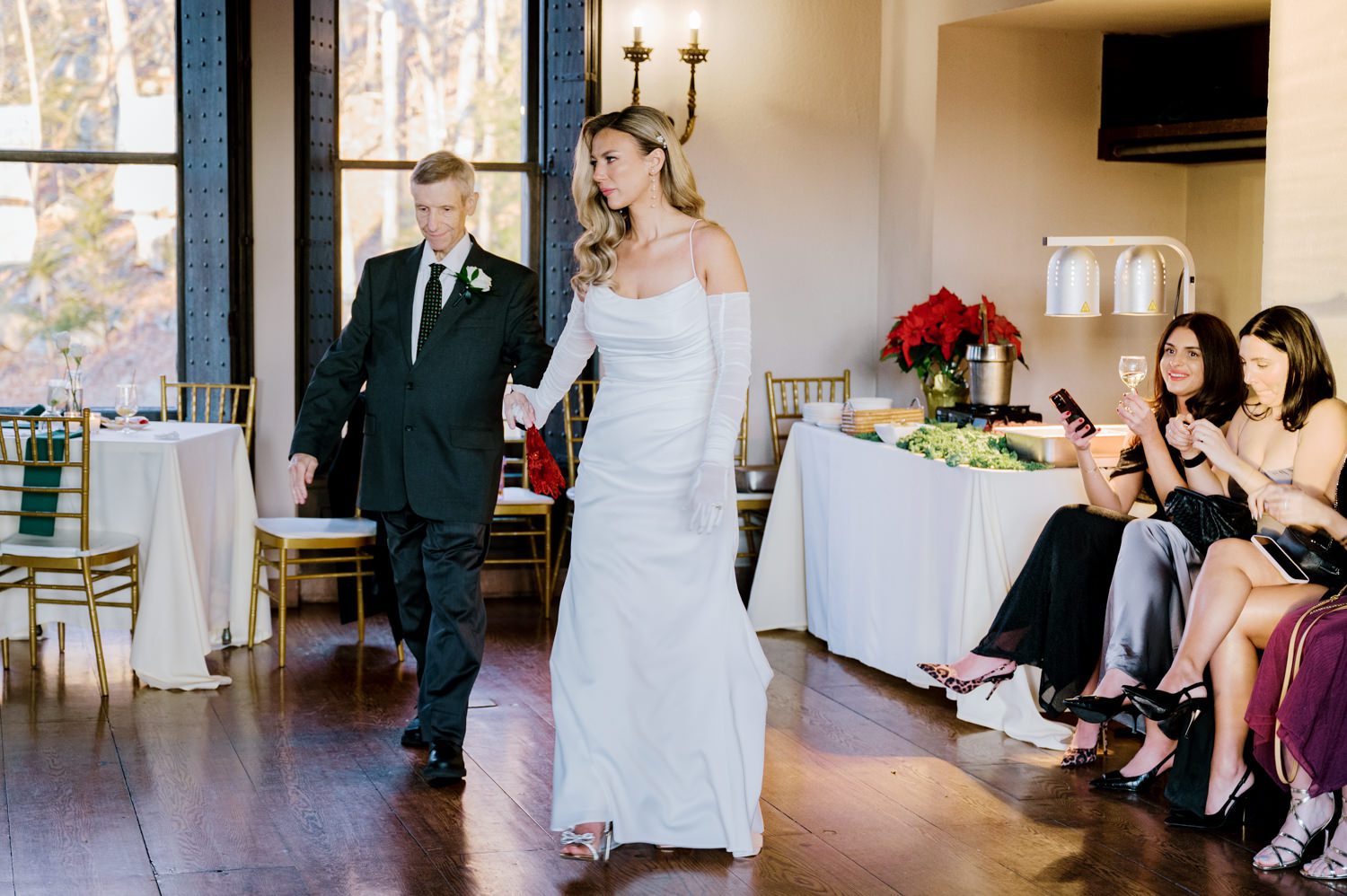 Kelsey and Liron Winter Wedding at Arrow Park, NY
My first wedding at Arrow Park was back in June 2022 when I had the pleasure of photographing Jackie and Aron’s wedding. From that moment, other wedding inquiries and opportunities arose, allowing me to capture the love stories of more wonderful couples at Arrow Park. That’s how I met Kelsey. Kelsey is the sales manager at Arrow Park, and since then, she has been a fan of my work. When it came time to plan her own wedding, I was delighted and honored that she chose me to document her beautiful celebration at Arrow Park.
Kelsey was well-prepared for the chilly weather, as she was getting married in December, so the wedding took place inside the mansion. When I arrived, Kelsey was finishing up her hair and makeup, just about ready to put on her dress. Families started to arrive, filling the space with warm greetings and laughter—one of my favorite scenes to witness on a wedding morning. Kelsey stepped into her dress, slipped on her gloves, and completed her final wedding preparations. She sparkled even more than the diamond on her finger as she walked over to see her groom.
As Kelsey walked down the aisle escorted by her father, emotions filled the room. Tears welled up in the eyes of their family and friends while Liron stood at the altar, watching her with a big smile. With their loved ones witnessing, Kelsey and Liron exchanged vows and sealed their marriage with a kiss.
Cocktail hour began with delicious hors d'oeuvres and drinks in hand, as guests excitedly welcomed the newlyweds into the room. Midway through the reception, Albanian dancers performed a traditional folk dance, bringing everyone to the dance floor as one big family. The night was filled with joy, laughter, and celebration. As all fun times do, the evening eventually came to an end, and we sent off Kelsey and Liron with a magical sparkler exit.
Winter Wedding Tips for Arrow Park, NY:
1. Embrace the Indoor Spaces: Arrow Park’s mansion provides an elegant and cozy setting for a winter wedding. The warm fireplaces and historic charm create a romantic atmosphere perfect for a chilly December day.
2. Prepare for the Cold: If you’re planning a winter wedding, consider stylish layers like faux fur wraps, long-sleeved dresses, or elegant gloves to stay warm while looking stunning.
3. Plan for Early Sunset: Winter days are shorter, so plan your timeline accordingly to make the most of natural light for photos. Consider a first look to capture beautiful portraits before it gets dark.
4. Add Seasonal Touches: Enhance the winter wedding ambiance with seasonal decor, such as candles, string lights, evergreen arrangements, and warm color palettes to complement the cozy indoor setting.
5. Offer Warm Beverages: Keep guests comfortable by serving hot cocoa, mulled wine, or warm cider during cocktail hour to add a festive and welcoming touch.
Kelsey and Liron’s wedding was a perfect example of how a winter celebration at Arrow Park can be both intimate and breathtaking. I was honored to capture their special day and look forward to photographing more magical winter weddings in this beautiful venue.
Kelsey and Liron's Arrow Park NY Wedding documented by Karis from Hey Karis New York, Brooklyn, Hudson Valley NY and Catskills NY and NJ Wedding and NYC Elopement Photographer.

