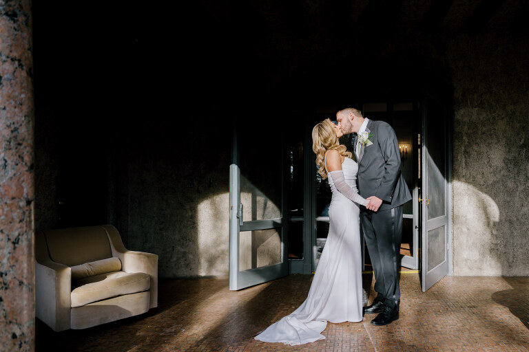 Kelsey and Liron Winter Wedding at Arrow Park, NY
My first wedding at Arrow Park was back in June 2022 when I had the pleasure of photographing Jackie and Aron’s wedding. From that moment, other wedding inquiries and opportunities arose, allowing me to capture the love stories of more wonderful couples at Arrow Park. That’s how I met Kelsey. Kelsey is the sales manager at Arrow Park, and since then, she has been a fan of my work. When it came time to plan her own wedding, I was delighted and honored that she chose me to document her beautiful celebration at Arrow Park.
Kelsey was well-prepared for the chilly weather, as she was getting married in December, so the wedding took place inside the mansion. When I arrived, Kelsey was finishing up her hair and makeup, just about ready to put on her dress. Families started to arrive, filling the space with warm greetings and laughter—one of my favorite scenes to witness on a wedding morning. Kelsey stepped into her dress, slipped on her gloves, and completed her final wedding preparations. She sparkled even more than the diamond on her finger as she walked over to see her groom.
As Kelsey walked down the aisle escorted by her father, emotions filled the room. Tears welled up in the eyes of their family and friends while Liron stood at the altar, watching her with a big smile. With their loved ones witnessing, Kelsey and Liron exchanged vows and sealed their marriage with a kiss.
Cocktail hour began with delicious hors d'oeuvres and drinks in hand, as guests excitedly welcomed the newlyweds into the room. Midway through the reception, Albanian dancers performed a traditional folk dance, bringing everyone to the dance floor as one big family. The night was filled with joy, laughter, and celebration. As all fun times do, the evening eventually came to an end, and we sent off Kelsey and Liron with a magical sparkler exit.
Winter Wedding Tips for Arrow Park, NY:
1. Embrace the Indoor Spaces: Arrow Park’s mansion provides an elegant and cozy setting for a winter wedding. The warm fireplaces and historic charm create a romantic atmosphere perfect for a chilly December day.
2. Prepare for the Cold: If you’re planning a winter wedding, consider stylish layers like faux fur wraps, long-sleeved dresses, or elegant gloves to stay warm while looking stunning.
3. Plan for Early Sunset: Winter days are shorter, so plan your timeline accordingly to make the most of natural light for photos. Consider a first look to capture beautiful portraits before it gets dark.
4. Add Seasonal Touches: Enhance the winter wedding ambiance with seasonal decor, such as candles, string lights, evergreen arrangements, and warm color palettes to complement the cozy indoor setting.
5. Offer Warm Beverages: Keep guests comfortable by serving hot cocoa, mulled wine, or warm cider during cocktail hour to add a festive and welcoming touch.
Kelsey and Liron’s wedding was a perfect example of how a winter celebration at Arrow Park can be both intimate and breathtaking. I was honored to capture their special day and look forward to photographing more magical winter weddings in this beautiful venue.
Kelsey and Liron's Arrow Park NY Wedding documented by Karis from Hey Karis New York, Brooklyn, Hudson Valley NY and Catskills NY and NJ Wedding and NYC Elopement Photographer.
