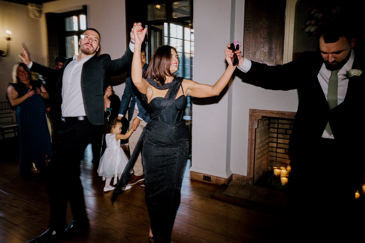 Kelsey and Liron Winter Wedding at Arrow Park, NY
My first wedding at Arrow Park was back in June 2022 when I had the pleasure of photographing Jackie and Aron’s wedding. From that moment, other wedding inquiries and opportunities arose, allowing me to capture the love stories of more wonderful couples at Arrow Park. That’s how I met Kelsey. Kelsey is the sales manager at Arrow Park, and since then, she has been a fan of my work. When it came time to plan her own wedding, I was delighted and honored that she chose me to document her beautiful celebration at Arrow Park.
Kelsey was well-prepared for the chilly weather, as she was getting married in December, so the wedding took place inside the mansion. When I arrived, Kelsey was finishing up her hair and makeup, just about ready to put on her dress. Families started to arrive, filling the space with warm greetings and laughter—one of my favorite scenes to witness on a wedding morning. Kelsey stepped into her dress, slipped on her gloves, and completed her final wedding preparations. She sparkled even more than the diamond on her finger as she walked over to see her groom.
As Kelsey walked down the aisle escorted by her father, emotions filled the room. Tears welled up in the eyes of their family and friends while Liron stood at the altar, watching her with a big smile. With their loved ones witnessing, Kelsey and Liron exchanged vows and sealed their marriage with a kiss.
Cocktail hour began with delicious hors d'oeuvres and drinks in hand, as guests excitedly welcomed the newlyweds into the room. Midway through the reception, Albanian dancers performed a traditional folk dance, bringing everyone to the dance floor as one big family. The night was filled with joy, laughter, and celebration. As all fun times do, the evening eventually came to an end, and we sent off Kelsey and Liron with a magical sparkler exit.
Winter Wedding Tips for Arrow Park, NY:
1. Embrace the Indoor Spaces: Arrow Park’s mansion provides an elegant and cozy setting for a winter wedding. The warm fireplaces and historic charm create a romantic atmosphere perfect for a chilly December day.
2. Prepare for the Cold: If you’re planning a winter wedding, consider stylish layers like faux fur wraps, long-sleeved dresses, or elegant gloves to stay warm while looking stunning.
3. Plan for Early Sunset: Winter days are shorter, so plan your timeline accordingly to make the most of natural light for photos. Consider a first look to capture beautiful portraits before it gets dark.
4. Add Seasonal Touches: Enhance the winter wedding ambiance with seasonal decor, such as candles, string lights, evergreen arrangements, and warm color palettes to complement the cozy indoor setting.
5. Offer Warm Beverages: Keep guests comfortable by serving hot cocoa, mulled wine, or warm cider during cocktail hour to add a festive and welcoming touch.
Kelsey and Liron’s wedding was a perfect example of how a winter celebration at Arrow Park can be both intimate and breathtaking. I was honored to capture their special day and look forward to photographing more magical winter weddings in this beautiful venue.
Kelsey and Liron's Arrow Park NY Wedding documented by Karis from Hey Karis New York, Brooklyn, Hudson Valley NY and Catskills NY and NJ Wedding and NYC Elopement Photographer.
