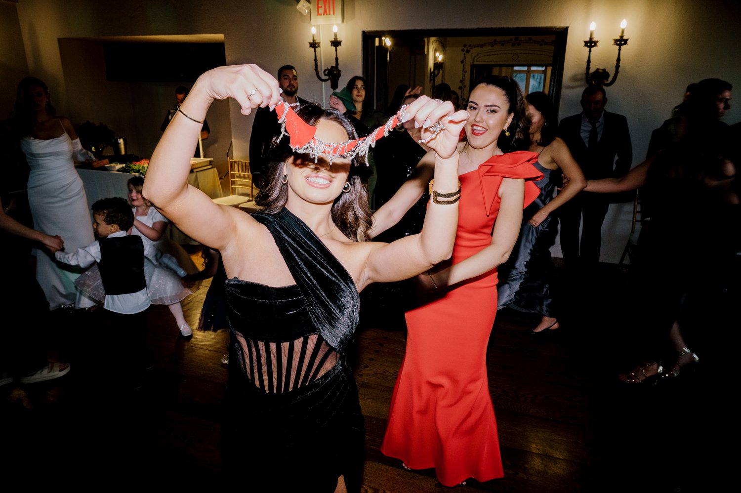 Kelsey and Liron Winter Wedding at Arrow Park, NY
My first wedding at Arrow Park was back in June 2022 when I had the pleasure of photographing Jackie and Aron’s wedding. From that moment, other wedding inquiries and opportunities arose, allowing me to capture the love stories of more wonderful couples at Arrow Park. That’s how I met Kelsey. Kelsey is the sales manager at Arrow Park, and since then, she has been a fan of my work. When it came time to plan her own wedding, I was delighted and honored that she chose me to document her beautiful celebration at Arrow Park.
Kelsey was well-prepared for the chilly weather, as she was getting married in December, so the wedding took place inside the mansion. When I arrived, Kelsey was finishing up her hair and makeup, just about ready to put on her dress. Families started to arrive, filling the space with warm greetings and laughter—one of my favorite scenes to witness on a wedding morning. Kelsey stepped into her dress, slipped on her gloves, and completed her final wedding preparations. She sparkled even more than the diamond on her finger as she walked over to see her groom.
As Kelsey walked down the aisle escorted by her father, emotions filled the room. Tears welled up in the eyes of their family and friends while Liron stood at the altar, watching her with a big smile. With their loved ones witnessing, Kelsey and Liron exchanged vows and sealed their marriage with a kiss.
Cocktail hour began with delicious hors d'oeuvres and drinks in hand, as guests excitedly welcomed the newlyweds into the room. Midway through the reception, Albanian dancers performed a traditional folk dance, bringing everyone to the dance floor as one big family. The night was filled with joy, laughter, and celebration. As all fun times do, the evening eventually came to an end, and we sent off Kelsey and Liron with a magical sparkler exit.
Winter Wedding Tips for Arrow Park, NY:
1. Embrace the Indoor Spaces: Arrow Park’s mansion provides an elegant and cozy setting for a winter wedding. The warm fireplaces and historic charm create a romantic atmosphere perfect for a chilly December day.
2. Prepare for the Cold: If you’re planning a winter wedding, consider stylish layers like faux fur wraps, long-sleeved dresses, or elegant gloves to stay warm while looking stunning.
3. Plan for Early Sunset: Winter days are shorter, so plan your timeline accordingly to make the most of natural light for photos. Consider a first look to capture beautiful portraits before it gets dark.
4. Add Seasonal Touches: Enhance the winter wedding ambiance with seasonal decor, such as candles, string lights, evergreen arrangements, and warm color palettes to complement the cozy indoor setting.
5. Offer Warm Beverages: Keep guests comfortable by serving hot cocoa, mulled wine, or warm cider during cocktail hour to add a festive and welcoming touch.
Kelsey and Liron’s wedding was a perfect example of how a winter celebration at Arrow Park can be both intimate and breathtaking. I was honored to capture their special day and look forward to photographing more magical winter weddings in this beautiful venue.
Kelsey and Liron's Arrow Park NY Wedding documented by Karis from Hey Karis New York, Brooklyn, Hudson Valley NY and Catskills NY and NJ Wedding and NYC Elopement Photographer.
