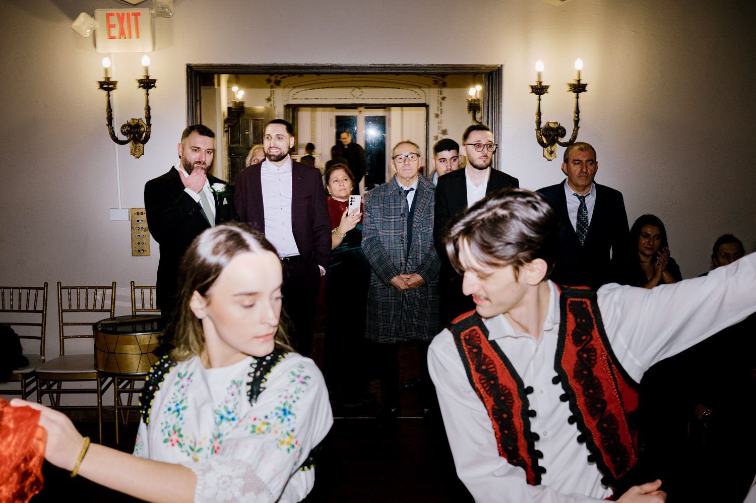 Kelsey and Liron Winter Wedding at Arrow Park, NY
My first wedding at Arrow Park was back in June 2022 when I had the pleasure of photographing Jackie and Aron’s wedding. From that moment, other wedding inquiries and opportunities arose, allowing me to capture the love stories of more wonderful couples at Arrow Park. That’s how I met Kelsey. Kelsey is the sales manager at Arrow Park, and since then, she has been a fan of my work. When it came time to plan her own wedding, I was delighted and honored that she chose me to document her beautiful celebration at Arrow Park.
Kelsey was well-prepared for the chilly weather, as she was getting married in December, so the wedding took place inside the mansion. When I arrived, Kelsey was finishing up her hair and makeup, just about ready to put on her dress. Families started to arrive, filling the space with warm greetings and laughter—one of my favorite scenes to witness on a wedding morning. Kelsey stepped into her dress, slipped on her gloves, and completed her final wedding preparations. She sparkled even more than the diamond on her finger as she walked over to see her groom.
As Kelsey walked down the aisle escorted by her father, emotions filled the room. Tears welled up in the eyes of their family and friends while Liron stood at the altar, watching her with a big smile. With their loved ones witnessing, Kelsey and Liron exchanged vows and sealed their marriage with a kiss.
Cocktail hour began with delicious hors d'oeuvres and drinks in hand, as guests excitedly welcomed the newlyweds into the room. Midway through the reception, Albanian dancers performed a traditional folk dance, bringing everyone to the dance floor as one big family. The night was filled with joy, laughter, and celebration. As all fun times do, the evening eventually came to an end, and we sent off Kelsey and Liron with a magical sparkler exit.
Winter Wedding Tips for Arrow Park, NY:
1. Embrace the Indoor Spaces: Arrow Park’s mansion provides an elegant and cozy setting for a winter wedding. The warm fireplaces and historic charm create a romantic atmosphere perfect for a chilly December day.
2. Prepare for the Cold: If you’re planning a winter wedding, consider stylish layers like faux fur wraps, long-sleeved dresses, or elegant gloves to stay warm while looking stunning.
3. Plan for Early Sunset: Winter days are shorter, so plan your timeline accordingly to make the most of natural light for photos. Consider a first look to capture beautiful portraits before it gets dark.
4. Add Seasonal Touches: Enhance the winter wedding ambiance with seasonal decor, such as candles, string lights, evergreen arrangements, and warm color palettes to complement the cozy indoor setting.
5. Offer Warm Beverages: Keep guests comfortable by serving hot cocoa, mulled wine, or warm cider during cocktail hour to add a festive and welcoming touch.
Kelsey and Liron’s wedding was a perfect example of how a winter celebration at Arrow Park can be both intimate and breathtaking. I was honored to capture their special day and look forward to photographing more magical winter weddings in this beautiful venue.
Kelsey and Liron's Arrow Park NY Wedding documented by Karis from Hey Karis New York, Brooklyn, Hudson Valley NY and Catskills NY and NJ Wedding and NYC Elopement Photographer.