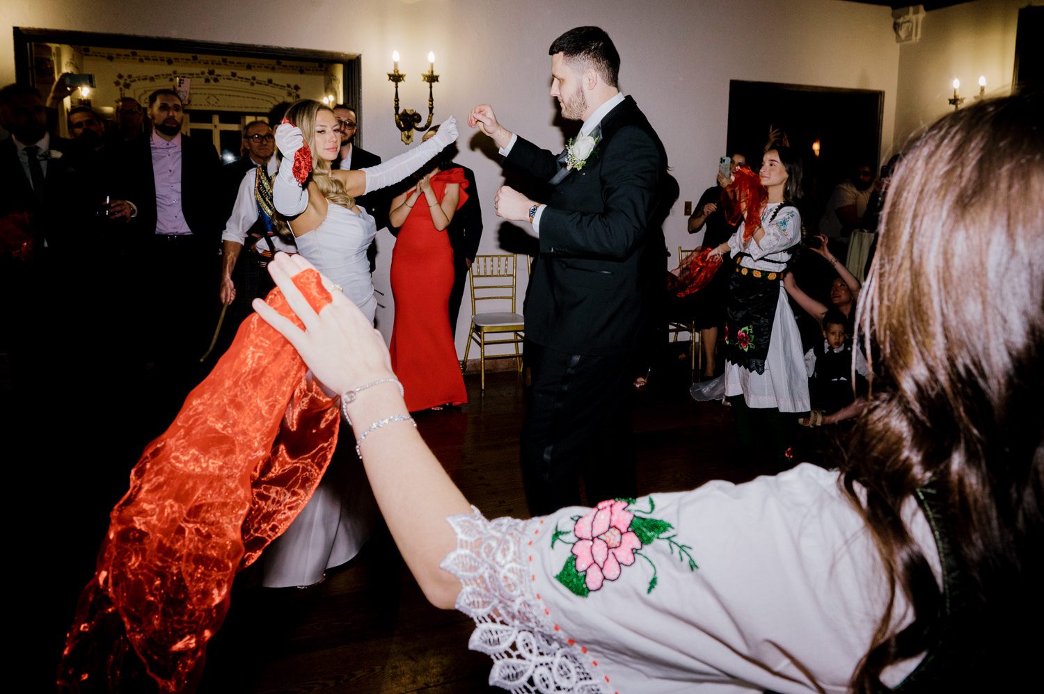 Kelsey and Liron Winter Wedding at Arrow Park, NY
My first wedding at Arrow Park was back in June 2022 when I had the pleasure of photographing Jackie and Aron’s wedding. From that moment, other wedding inquiries and opportunities arose, allowing me to capture the love stories of more wonderful couples at Arrow Park. That’s how I met Kelsey. Kelsey is the sales manager at Arrow Park, and since then, she has been a fan of my work. When it came time to plan her own wedding, I was delighted and honored that she chose me to document her beautiful celebration at Arrow Park.
Kelsey was well-prepared for the chilly weather, as she was getting married in December, so the wedding took place inside the mansion. When I arrived, Kelsey was finishing up her hair and makeup, just about ready to put on her dress. Families started to arrive, filling the space with warm greetings and laughter—one of my favorite scenes to witness on a wedding morning. Kelsey stepped into her dress, slipped on her gloves, and completed her final wedding preparations. She sparkled even more than the diamond on her finger as she walked over to see her groom.
As Kelsey walked down the aisle escorted by her father, emotions filled the room. Tears welled up in the eyes of their family and friends while Liron stood at the altar, watching her with a big smile. With their loved ones witnessing, Kelsey and Liron exchanged vows and sealed their marriage with a kiss.
Cocktail hour began with delicious hors d'oeuvres and drinks in hand, as guests excitedly welcomed the newlyweds into the room. Midway through the reception, Albanian dancers performed a traditional folk dance, bringing everyone to the dance floor as one big family. The night was filled with joy, laughter, and celebration. As all fun times do, the evening eventually came to an end, and we sent off Kelsey and Liron with a magical sparkler exit.
Winter Wedding Tips for Arrow Park, NY:
1. Embrace the Indoor Spaces: Arrow Park’s mansion provides an elegant and cozy setting for a winter wedding. The warm fireplaces and historic charm create a romantic atmosphere perfect for a chilly December day.
2. Prepare for the Cold: If you’re planning a winter wedding, consider stylish layers like faux fur wraps, long-sleeved dresses, or elegant gloves to stay warm while looking stunning.
3. Plan for Early Sunset: Winter days are shorter, so plan your timeline accordingly to make the most of natural light for photos. Consider a first look to capture beautiful portraits before it gets dark.
4. Add Seasonal Touches: Enhance the winter wedding ambiance with seasonal decor, such as candles, string lights, evergreen arrangements, and warm color palettes to complement the cozy indoor setting.
5. Offer Warm Beverages: Keep guests comfortable by serving hot cocoa, mulled wine, or warm cider during cocktail hour to add a festive and welcoming touch.
Kelsey and Liron’s wedding was a perfect example of how a winter celebration at Arrow Park can be both intimate and breathtaking. I was honored to capture their special day and look forward to photographing more magical winter weddings in this beautiful venue.
Kelsey and Liron's Arrow Park NY Wedding documented by Karis from Hey Karis New York, Brooklyn, Hudson Valley NY and Catskills NY and NJ Wedding and NYC Elopement Photographer.
