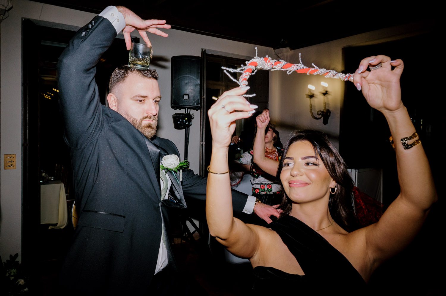 Kelsey and Liron Winter Wedding at Arrow Park, NY
My first wedding at Arrow Park was back in June 2022 when I had the pleasure of photographing Jackie and Aron’s wedding. From that moment, other wedding inquiries and opportunities arose, allowing me to capture the love stories of more wonderful couples at Arrow Park. That’s how I met Kelsey. Kelsey is the sales manager at Arrow Park, and since then, she has been a fan of my work. When it came time to plan her own wedding, I was delighted and honored that she chose me to document her beautiful celebration at Arrow Park.
Kelsey was well-prepared for the chilly weather, as she was getting married in December, so the wedding took place inside the mansion. When I arrived, Kelsey was finishing up her hair and makeup, just about ready to put on her dress. Families started to arrive, filling the space with warm greetings and laughter—one of my favorite scenes to witness on a wedding morning. Kelsey stepped into her dress, slipped on her gloves, and completed her final wedding preparations. She sparkled even more than the diamond on her finger as she walked over to see her groom.
As Kelsey walked down the aisle escorted by her father, emotions filled the room. Tears welled up in the eyes of their family and friends while Liron stood at the altar, watching her with a big smile. With their loved ones witnessing, Kelsey and Liron exchanged vows and sealed their marriage with a kiss.
Cocktail hour began with delicious hors d'oeuvres and drinks in hand, as guests excitedly welcomed the newlyweds into the room. Midway through the reception, Albanian dancers performed a traditional folk dance, bringing everyone to the dance floor as one big family. The night was filled with joy, laughter, and celebration. As all fun times do, the evening eventually came to an end, and we sent off Kelsey and Liron with a magical sparkler exit.
Winter Wedding Tips for Arrow Park, NY:
1. Embrace the Indoor Spaces: Arrow Park’s mansion provides an elegant and cozy setting for a winter wedding. The warm fireplaces and historic charm create a romantic atmosphere perfect for a chilly December day.
2. Prepare for the Cold: If you’re planning a winter wedding, consider stylish layers like faux fur wraps, long-sleeved dresses, or elegant gloves to stay warm while looking stunning.
3. Plan for Early Sunset: Winter days are shorter, so plan your timeline accordingly to make the most of natural light for photos. Consider a first look to capture beautiful portraits before it gets dark.
4. Add Seasonal Touches: Enhance the winter wedding ambiance with seasonal decor, such as candles, string lights, evergreen arrangements, and warm color palettes to complement the cozy indoor setting.
5. Offer Warm Beverages: Keep guests comfortable by serving hot cocoa, mulled wine, or warm cider during cocktail hour to add a festive and welcoming touch.
Kelsey and Liron’s wedding was a perfect example of how a winter celebration at Arrow Park can be both intimate and breathtaking. I was honored to capture their special day and look forward to photographing more magical winter weddings in this beautiful venue.
Kelsey and Liron's Arrow Park NY Wedding documented by Karis from Hey Karis New York, Brooklyn, Hudson Valley NY and Catskills NY and NJ Wedding and NYC Elopement Photographer.
